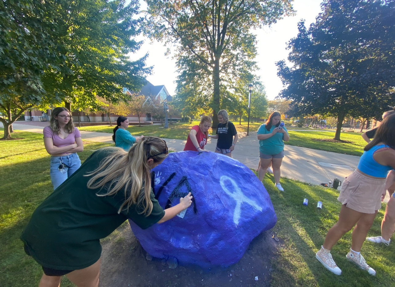 Alpha Chi Omega painting the rock