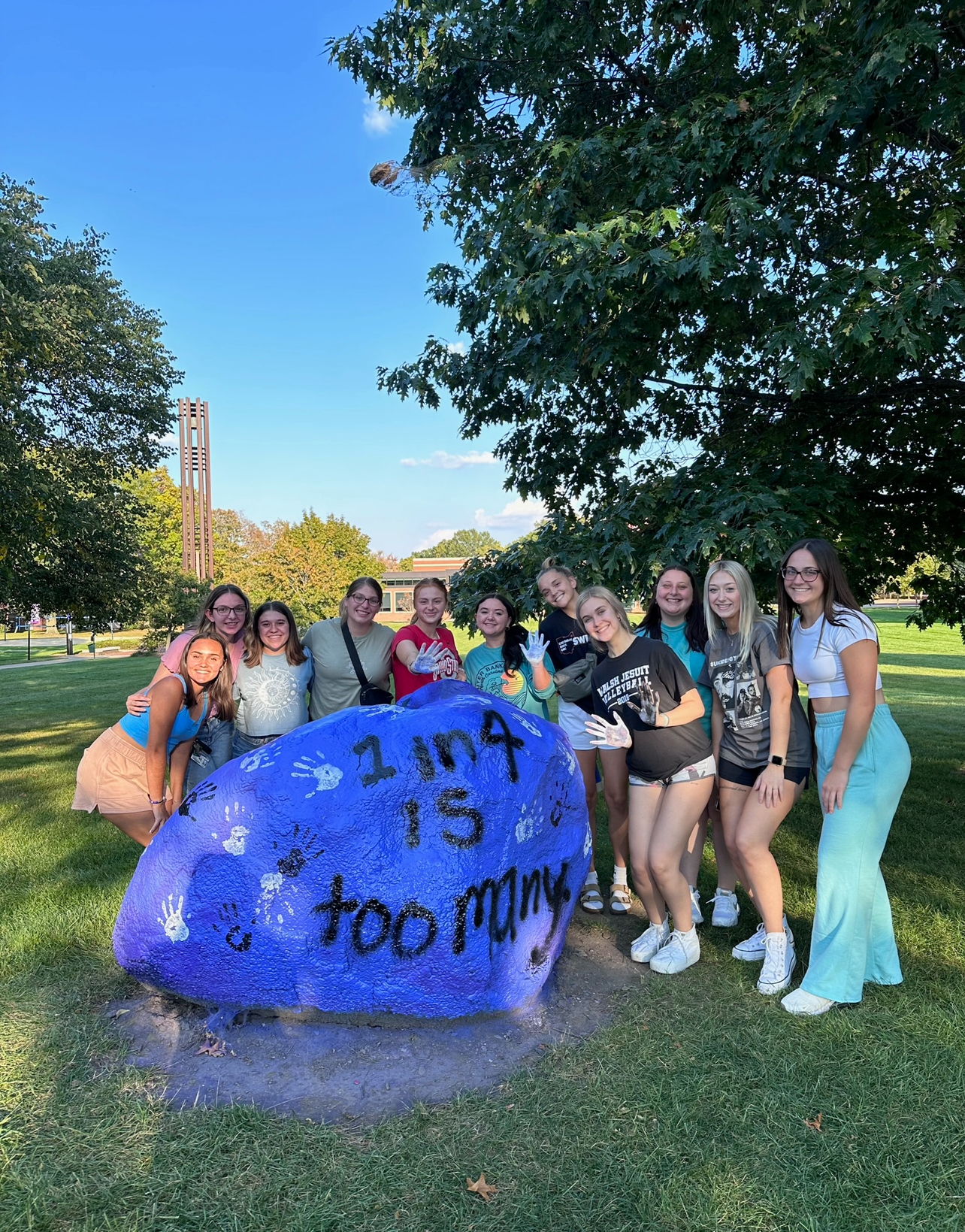 Alpha Chi Omega with the rock they painted
