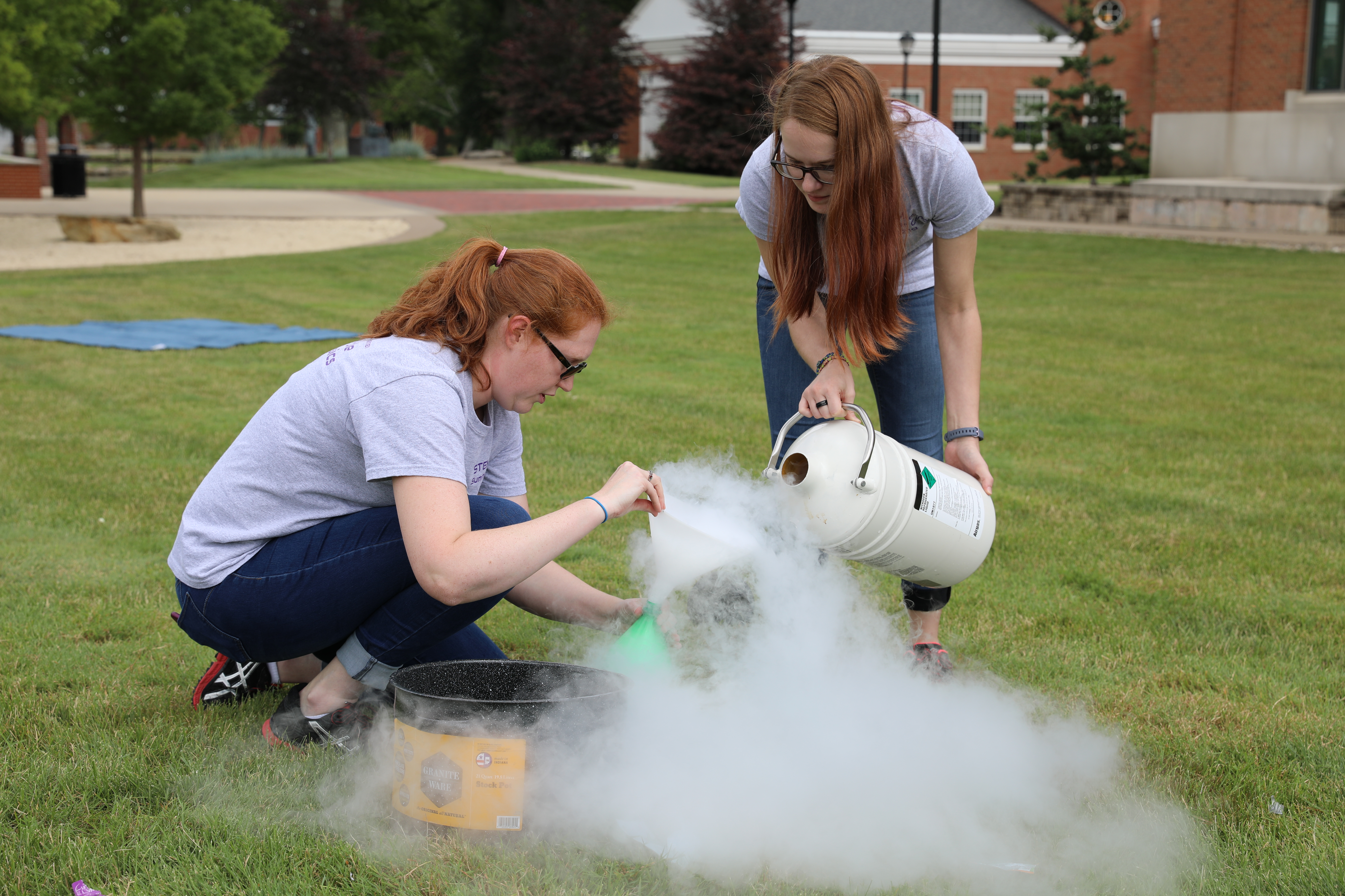 Action shot of program director Teeling-Smith with a student performing experiment at the university of mount union.