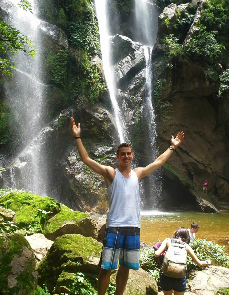 Student in front of waterfall in Chaing Mai Thailand