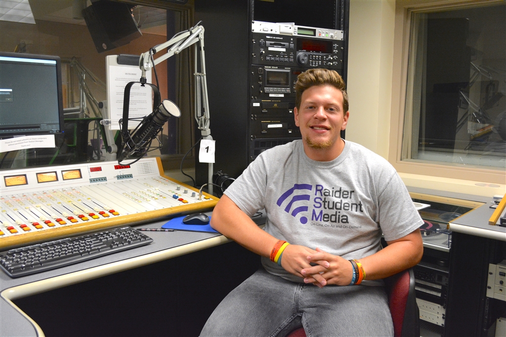 Joe Mertens sitting in a radio station booth 