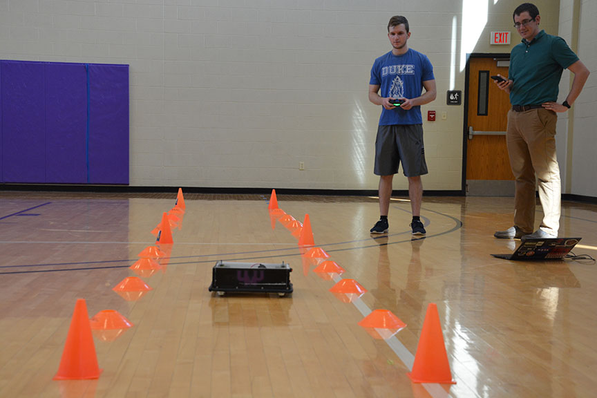 Students testing robotic football players