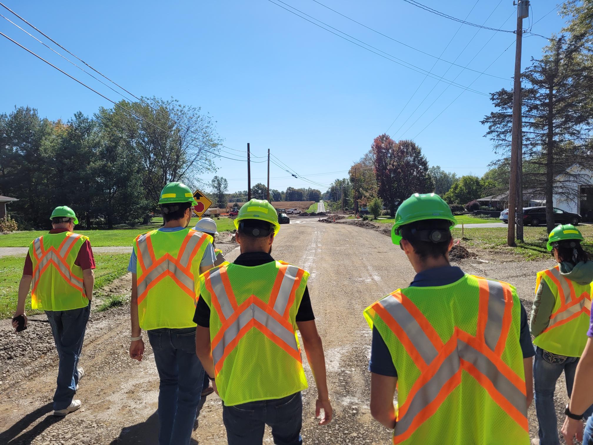 civil engineering students in neon vests at worksite