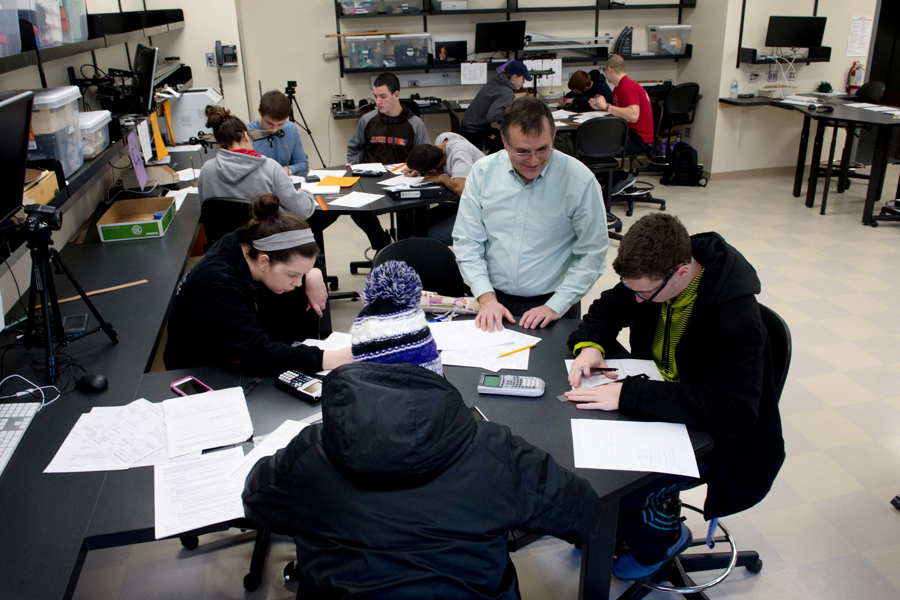 Professor with students in physics lab