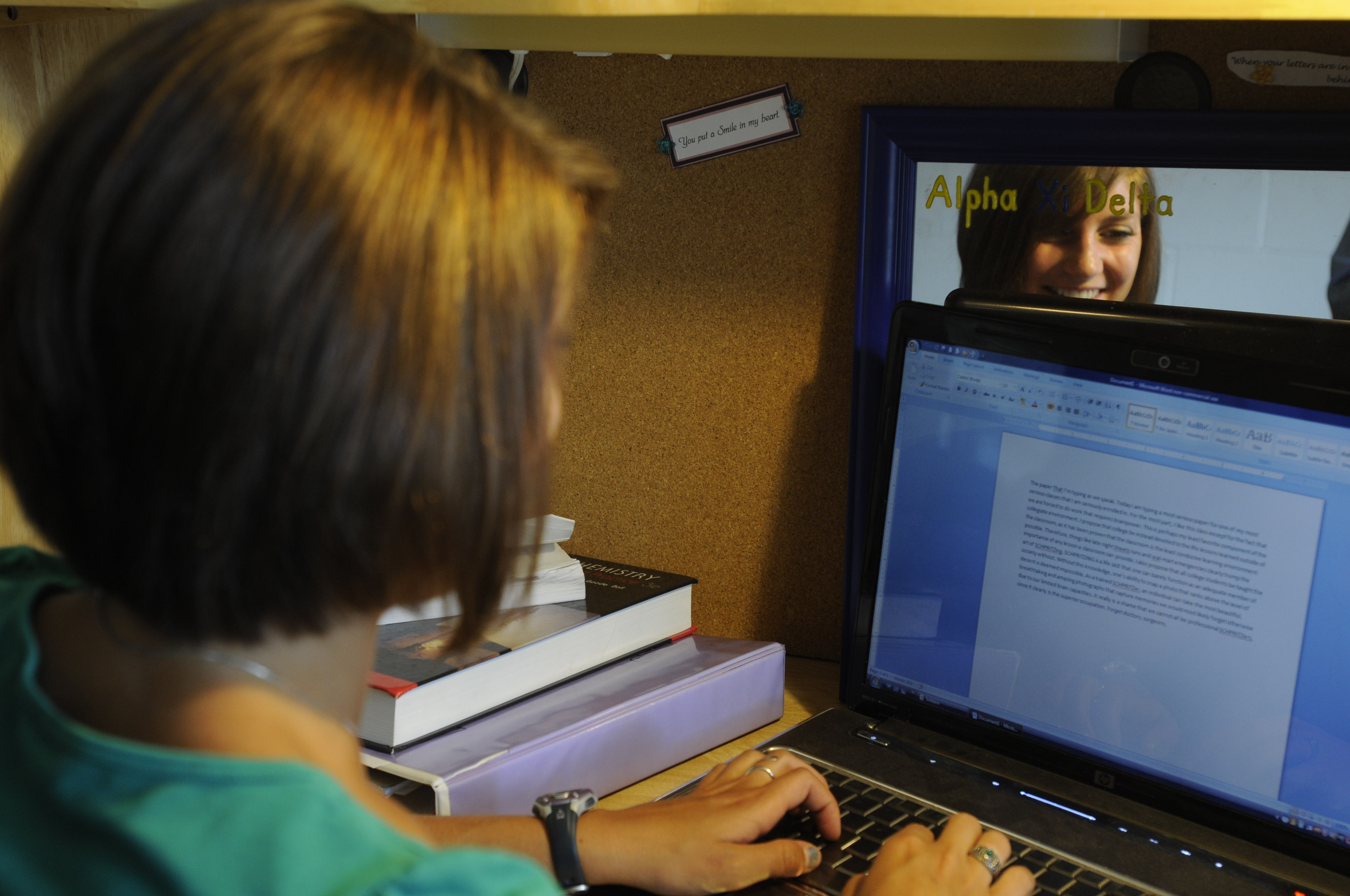 Student on laptop in residence hall room