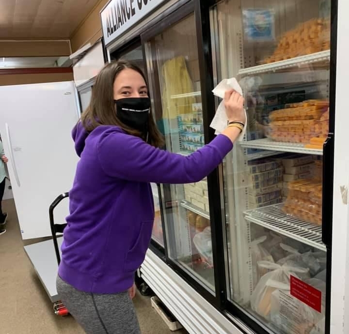 student cleaning pantry