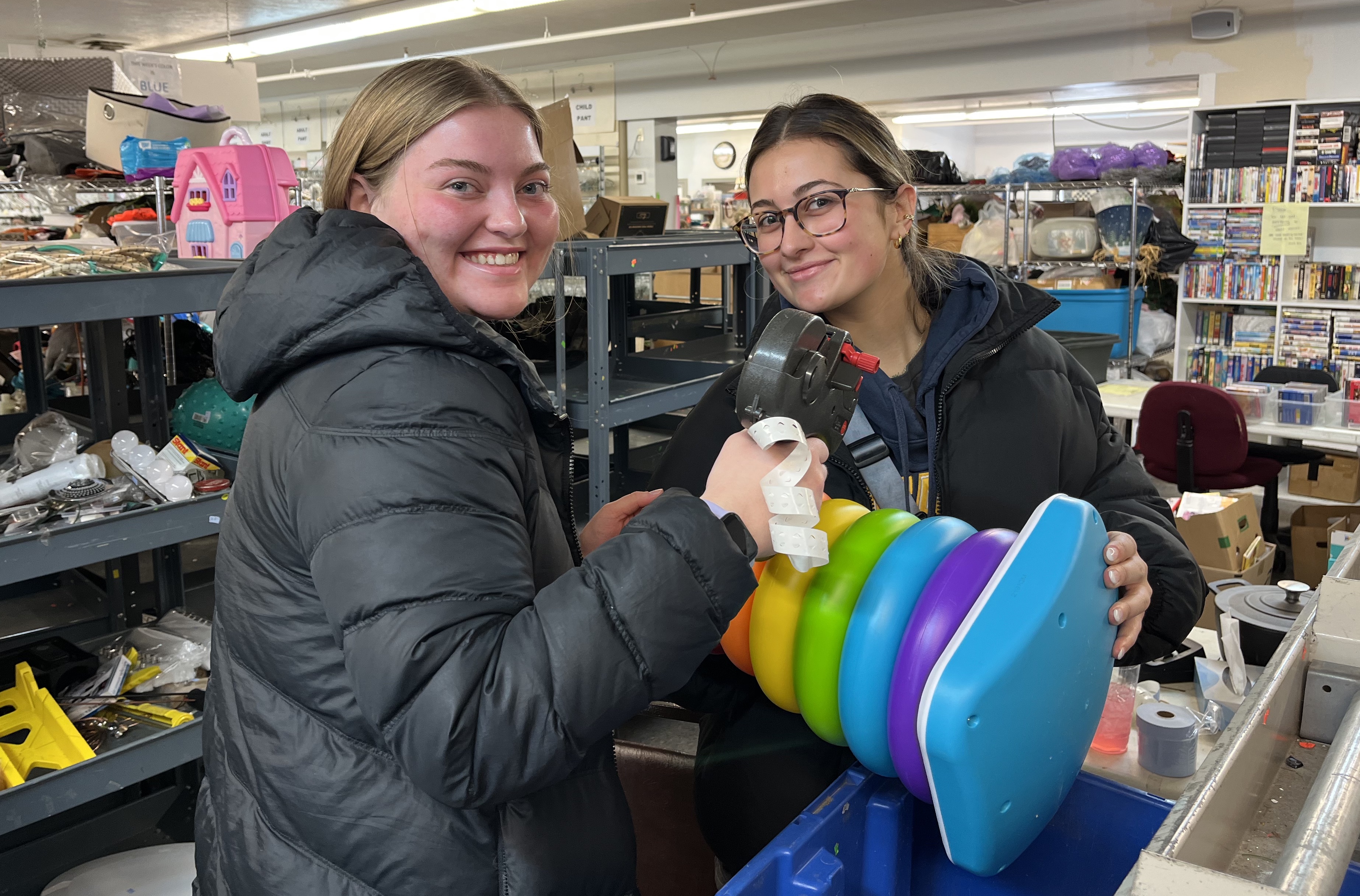 students holding toy in habitat restore store
