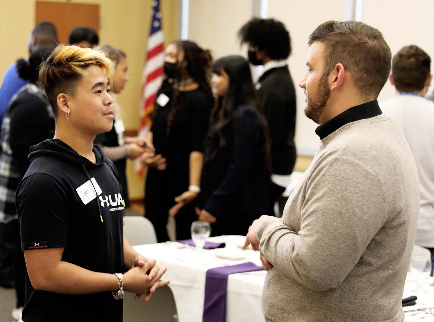 two students standing and talking
