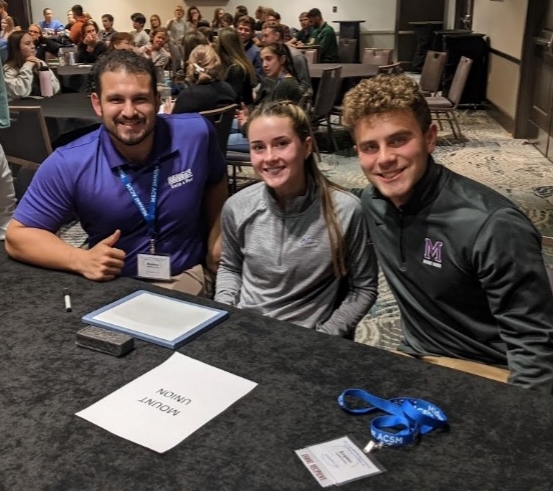 three students sitting at a table