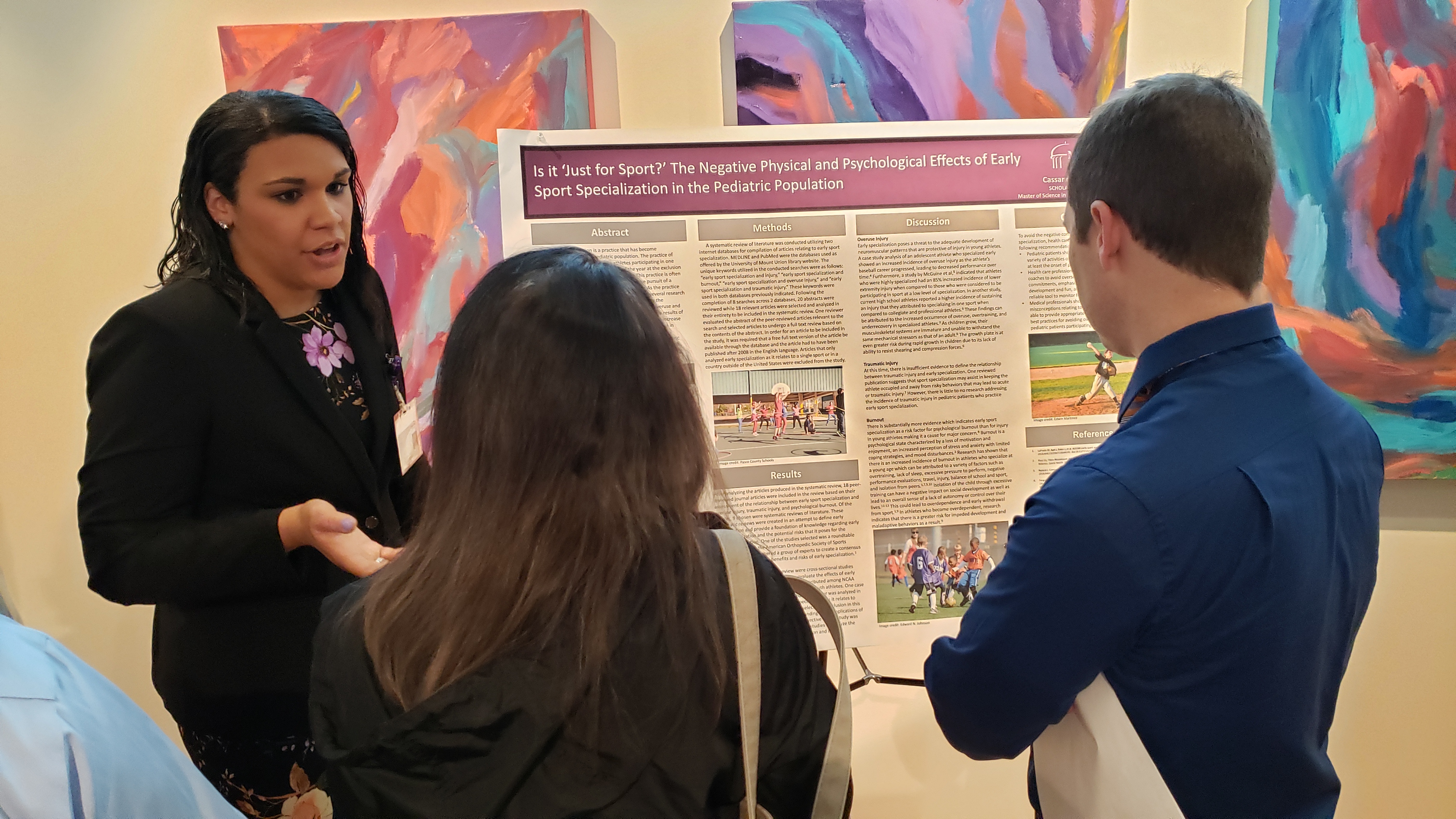 A student presenting a research poster during SCHOLAR Day 2019