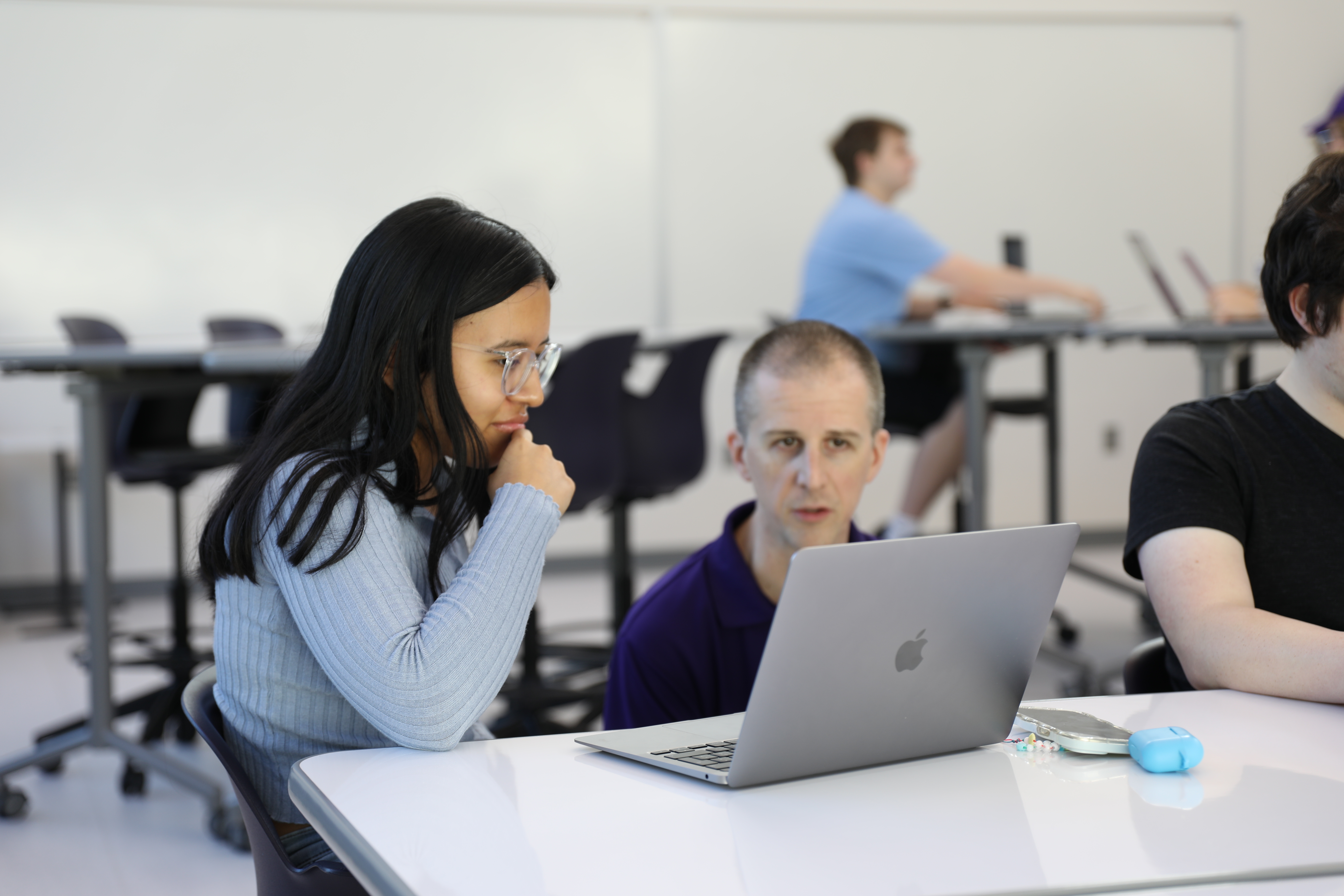 Student and professor working on laptop