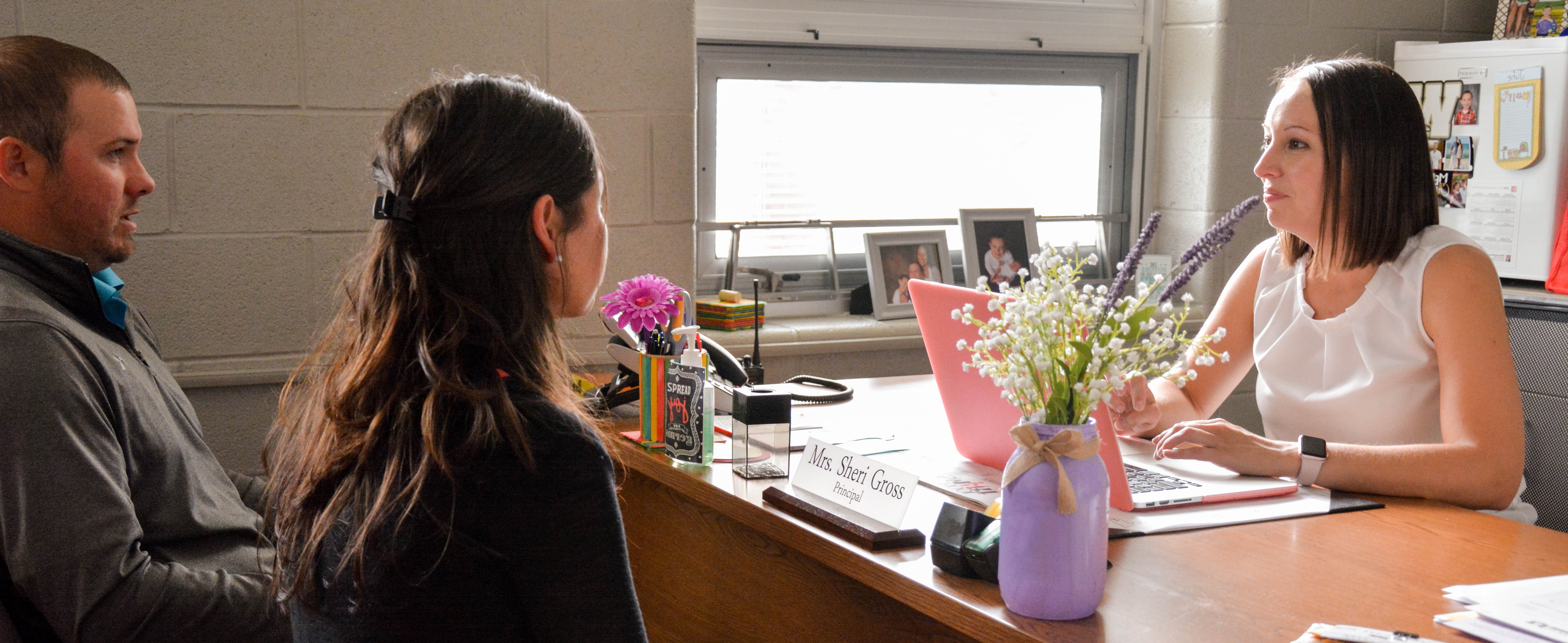 Elementary school principal having a meeting in her office 