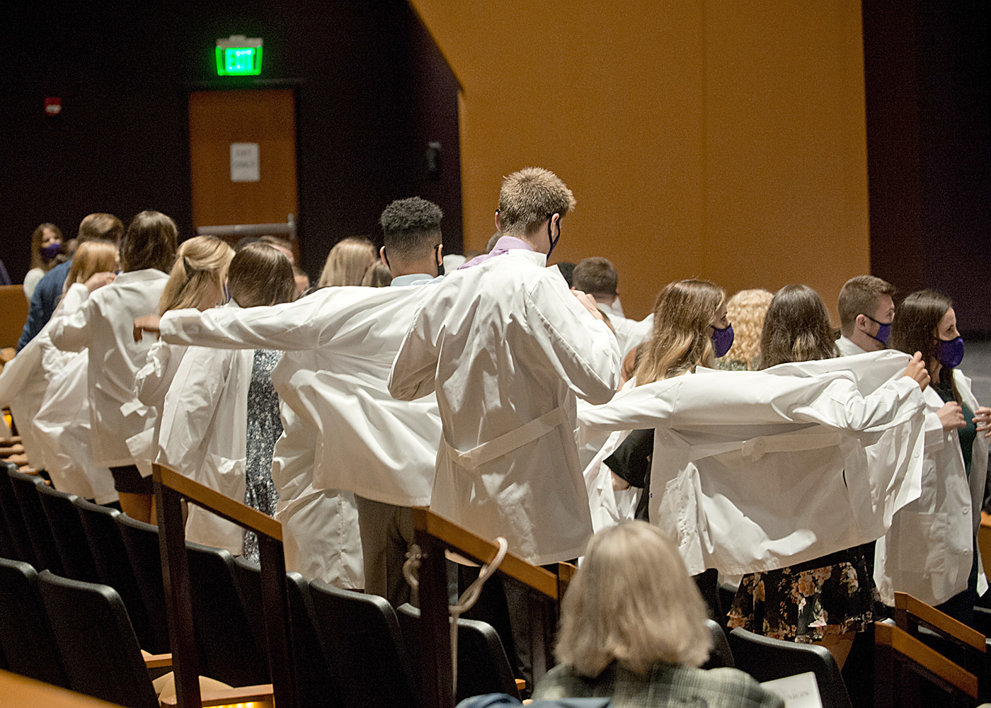 PT students putting on their white coats