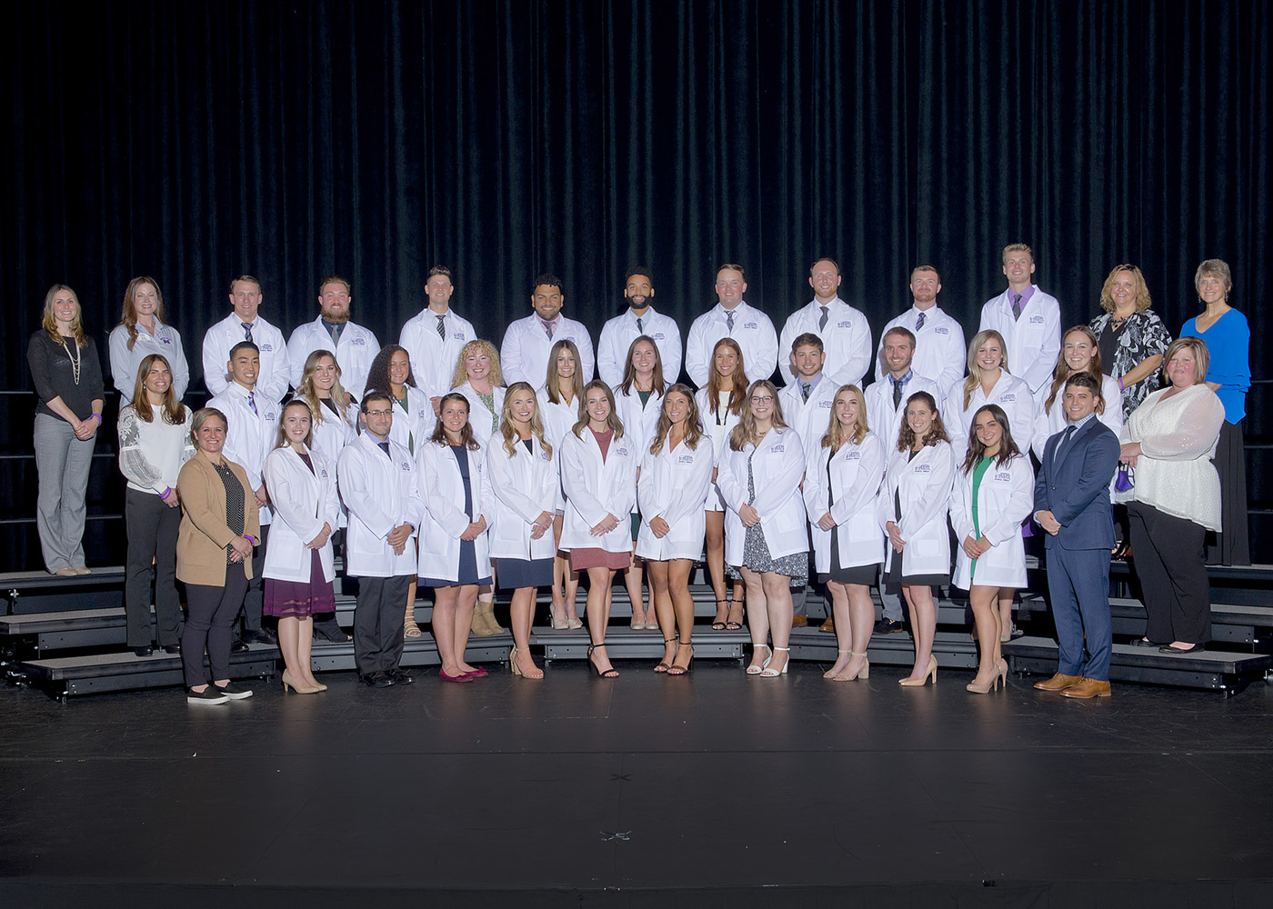 The 2021 White Coat Ceremony class standing on stage