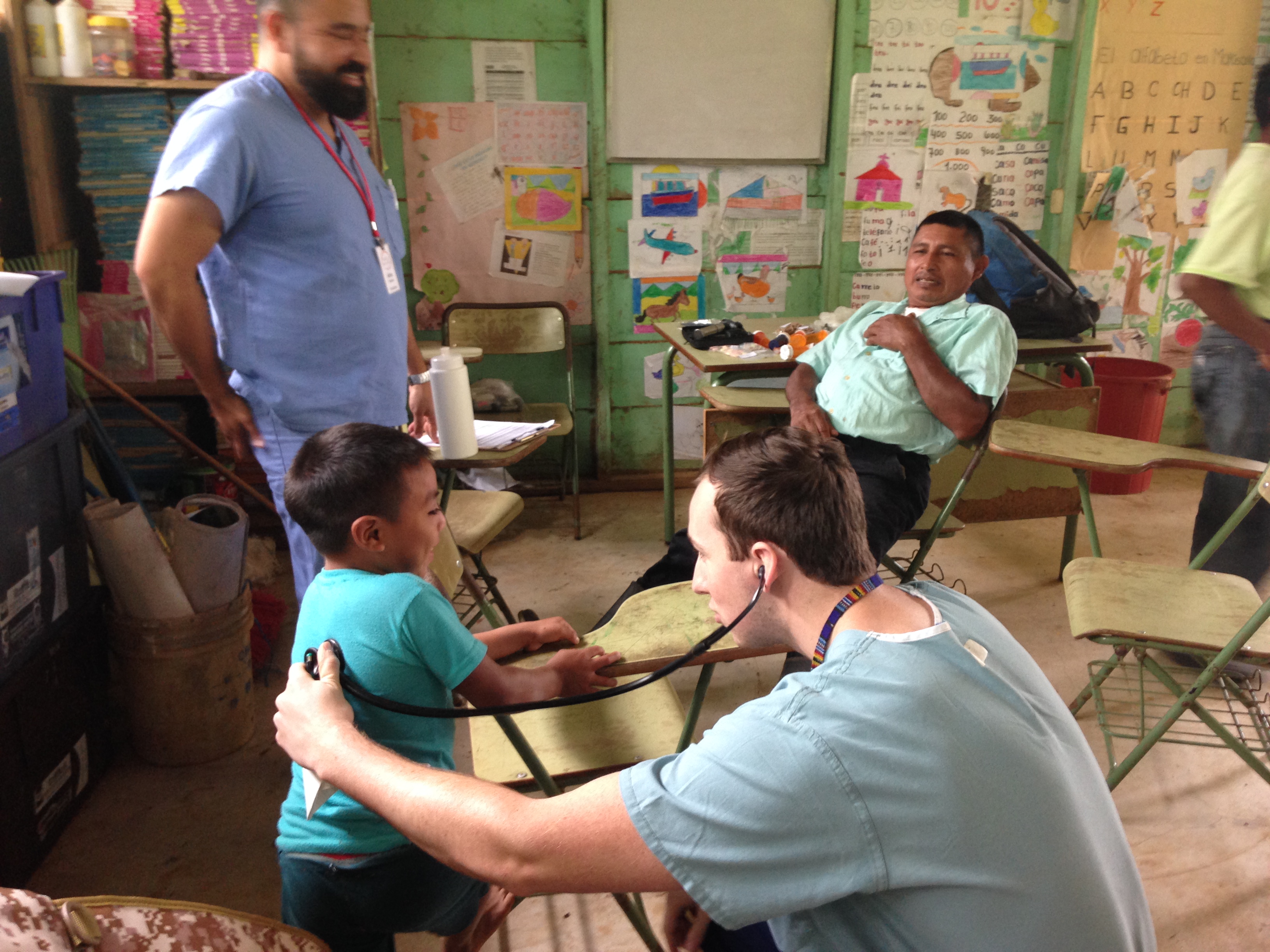 PA student providing care to child in Guatemala