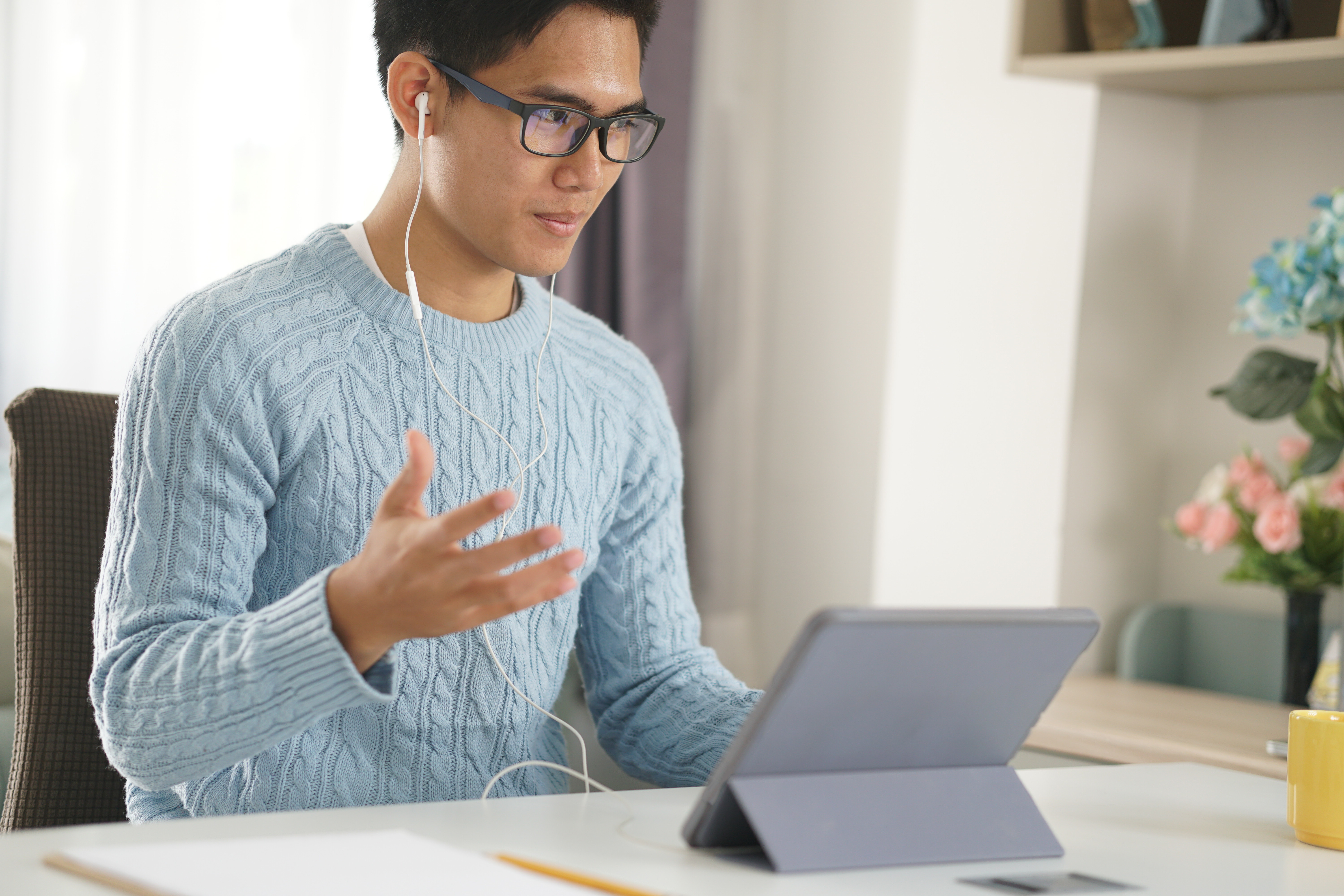 man sitting and working on tablet