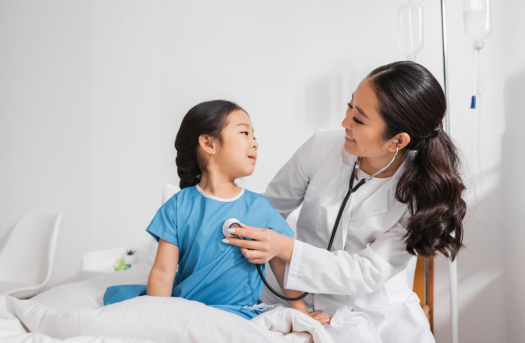 Family Nurse Practitioner performing a checkup on a young child in her office. 