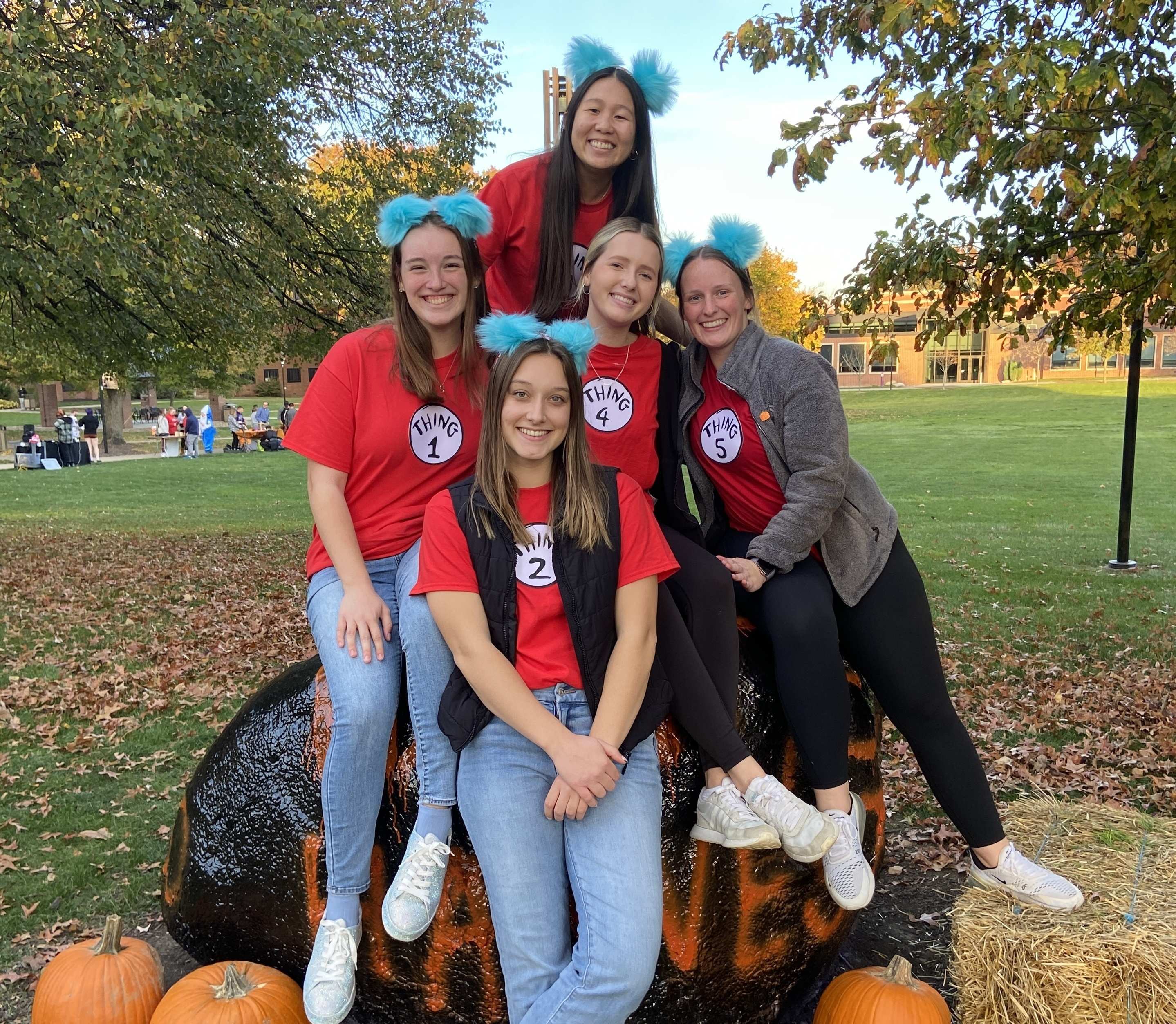 students sitting on rock in dr seuss "thing" shirts
