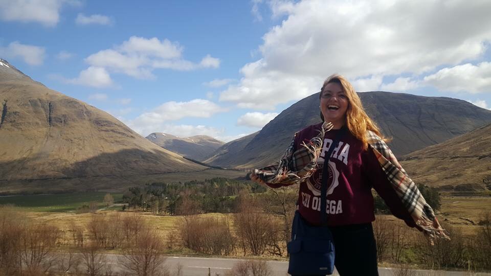 Student in front of rolling hills in Scotland