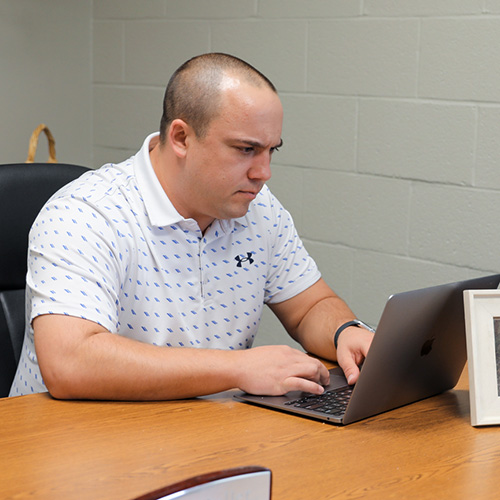 adult student on computer in office