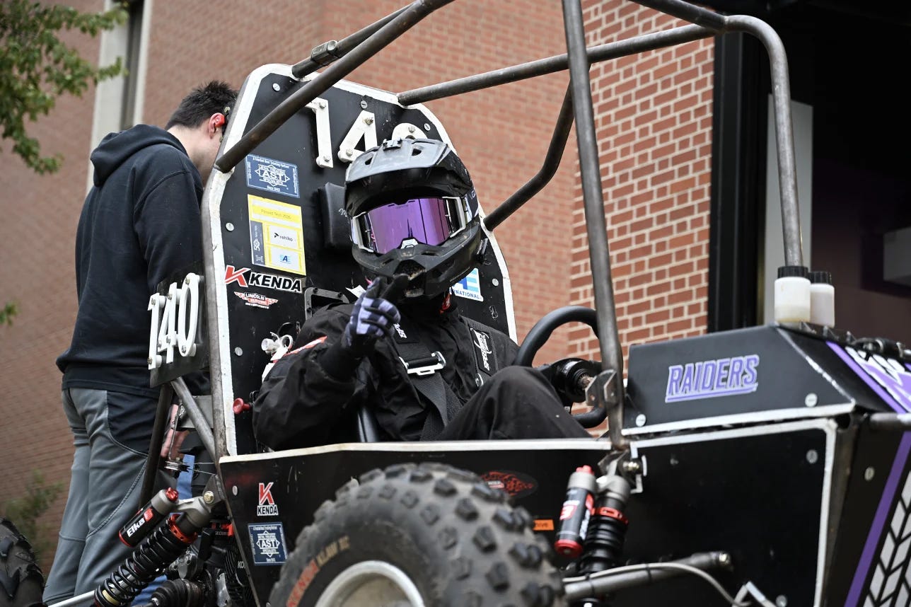 Student driving baja car