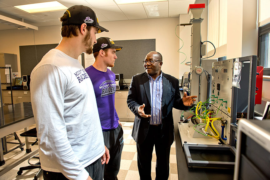 Engineering professor instructing students in a lab