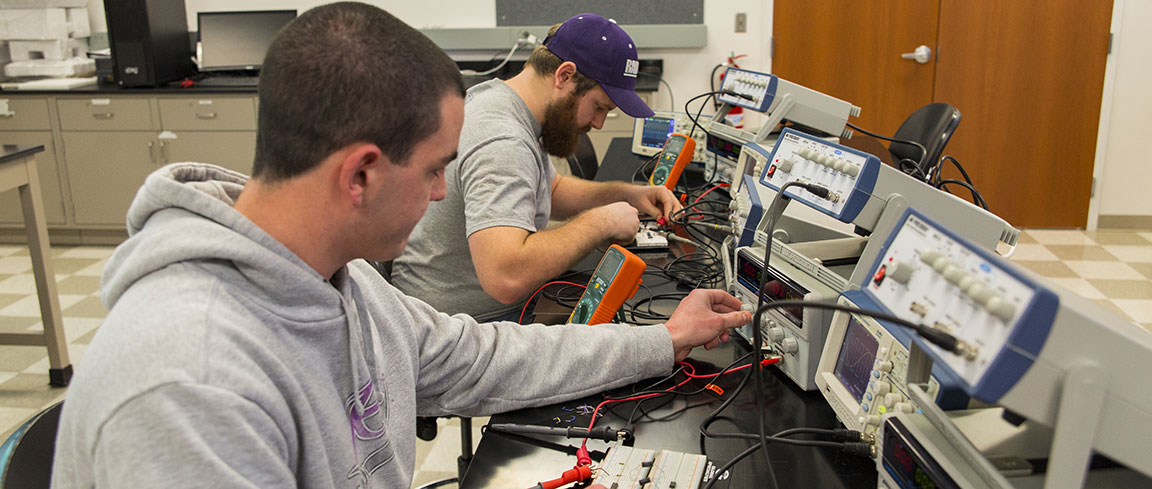 Electrical engineering students working in a lab