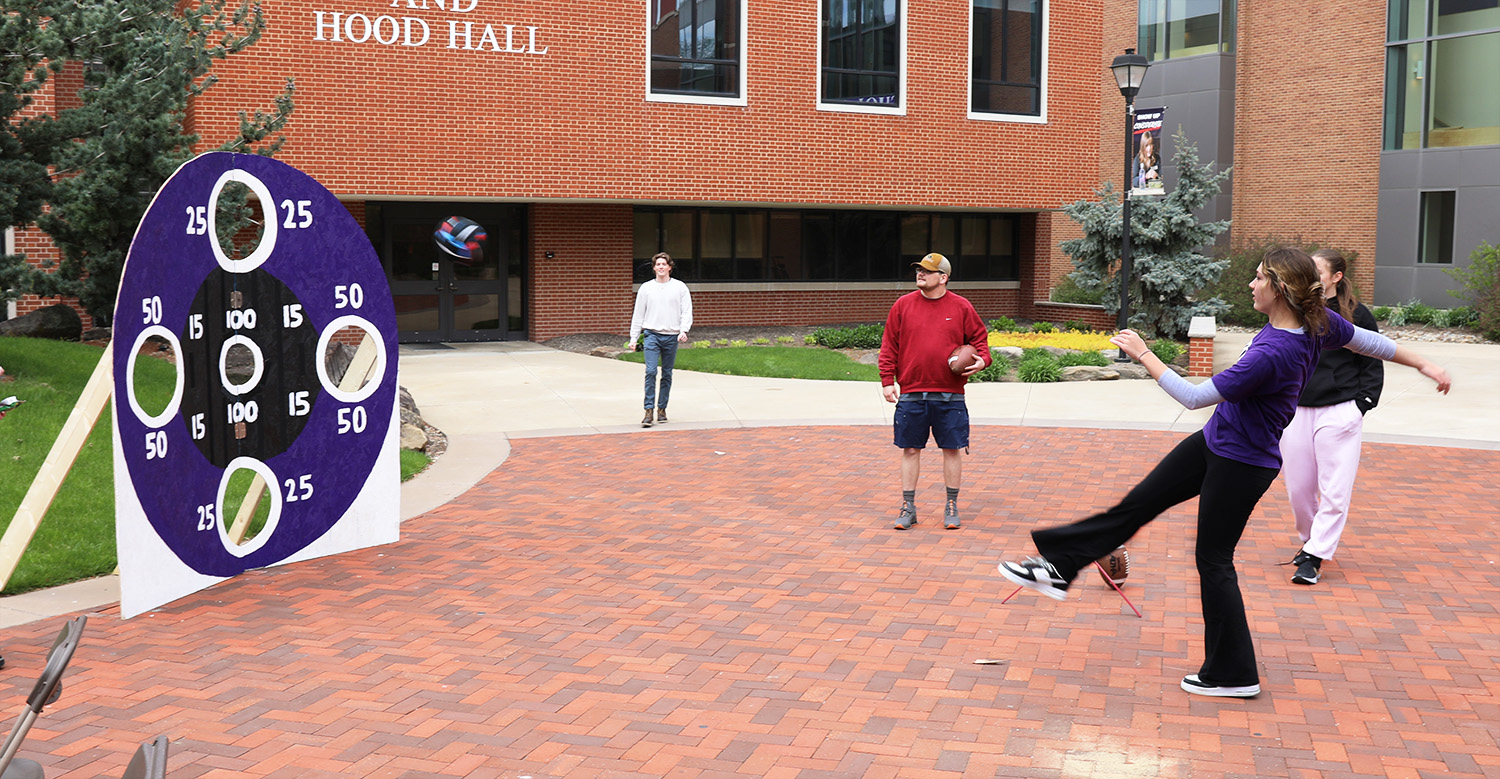 student kicking ball at game