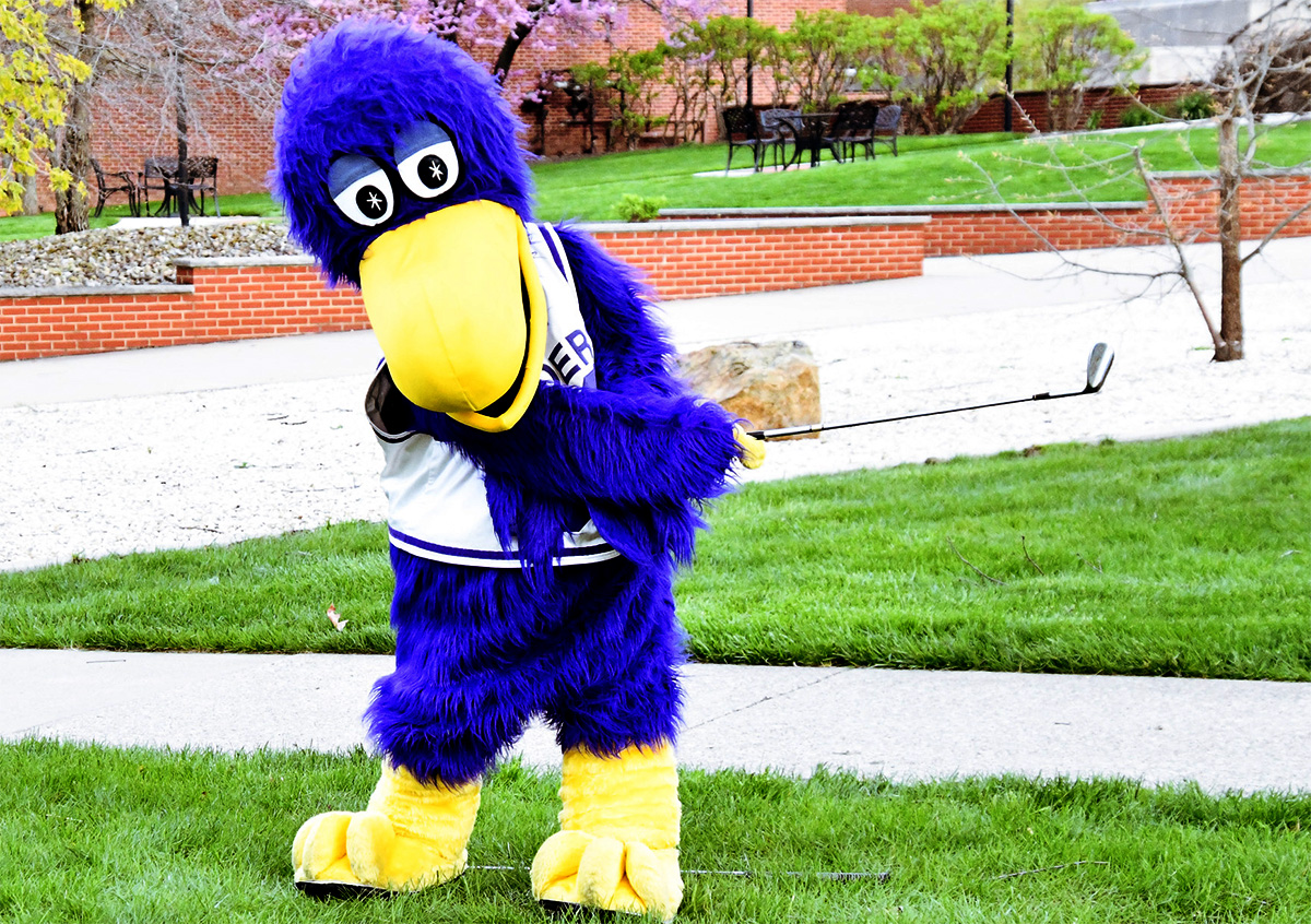 mascot hitting golf ball