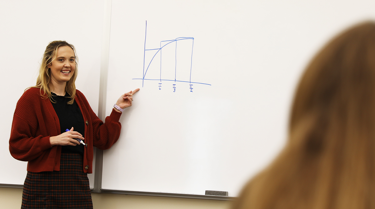 Mathematics professor in front of an equation