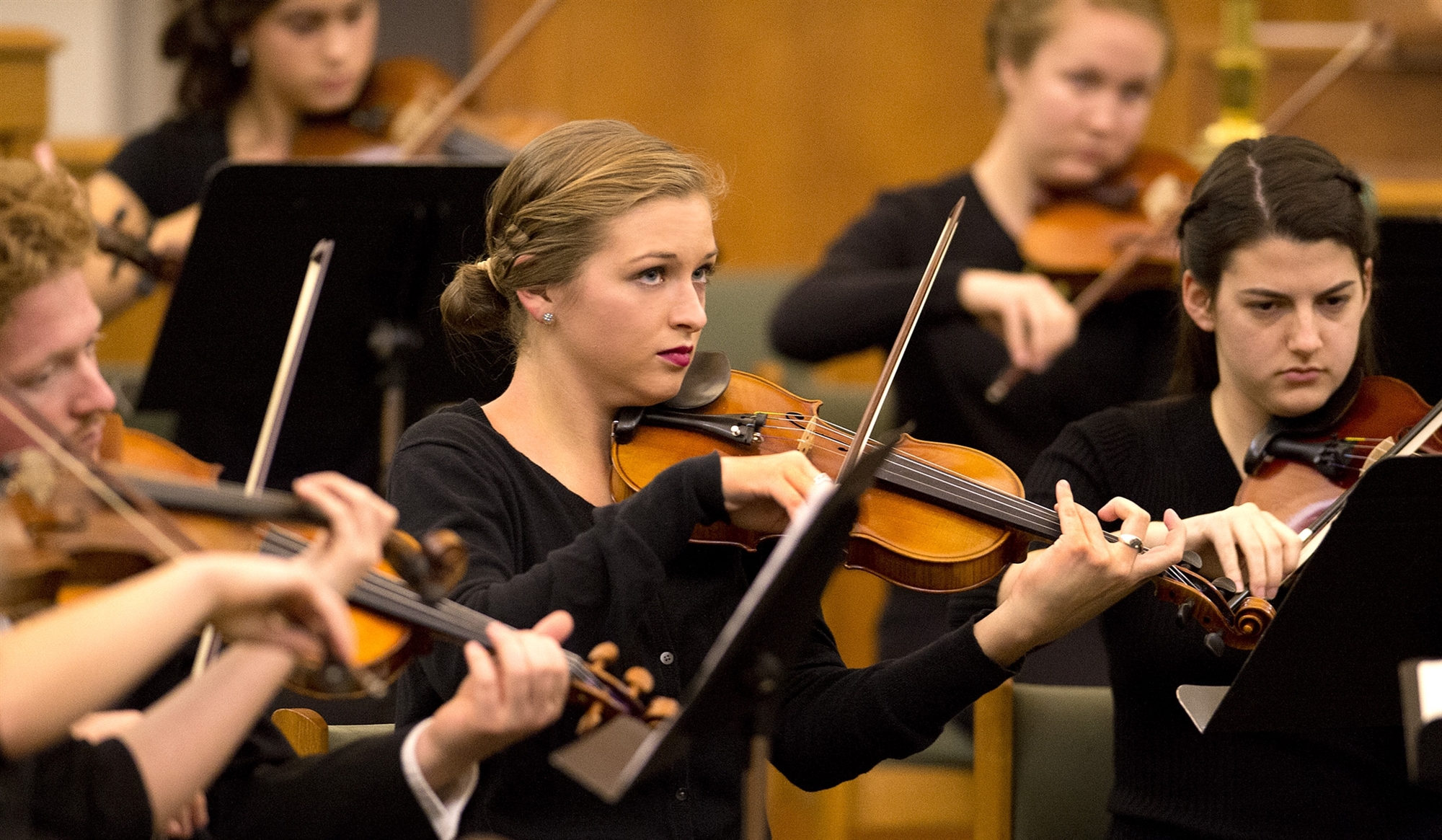 Musicians playing violins on stage 