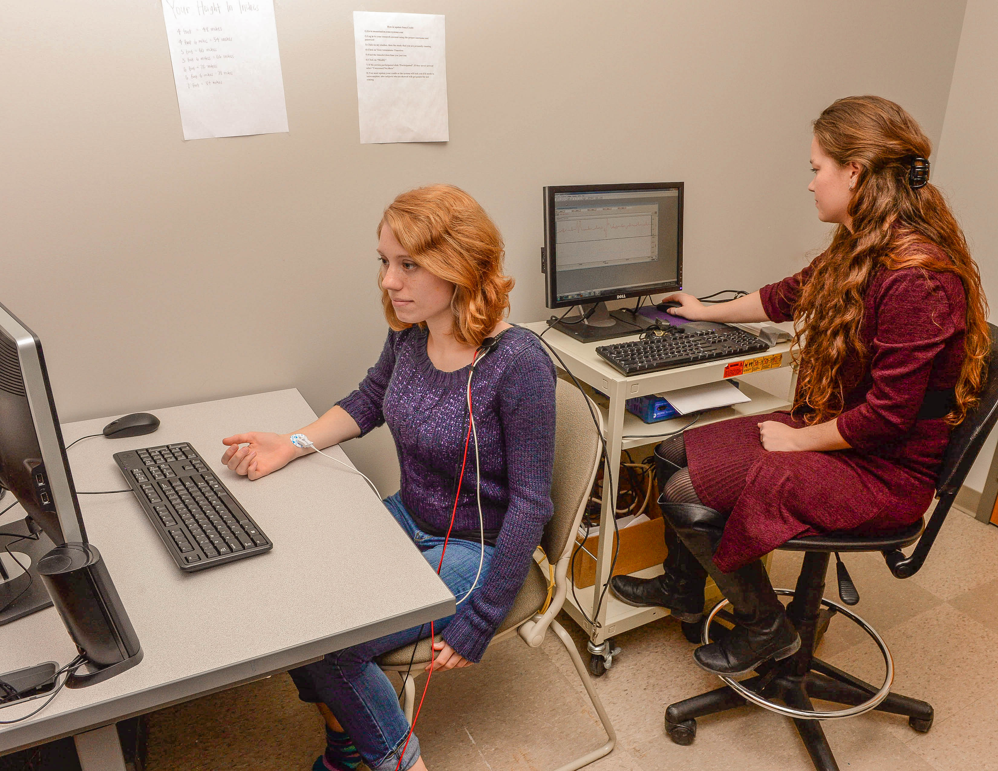 Two female students sitting working on computers in a classroom