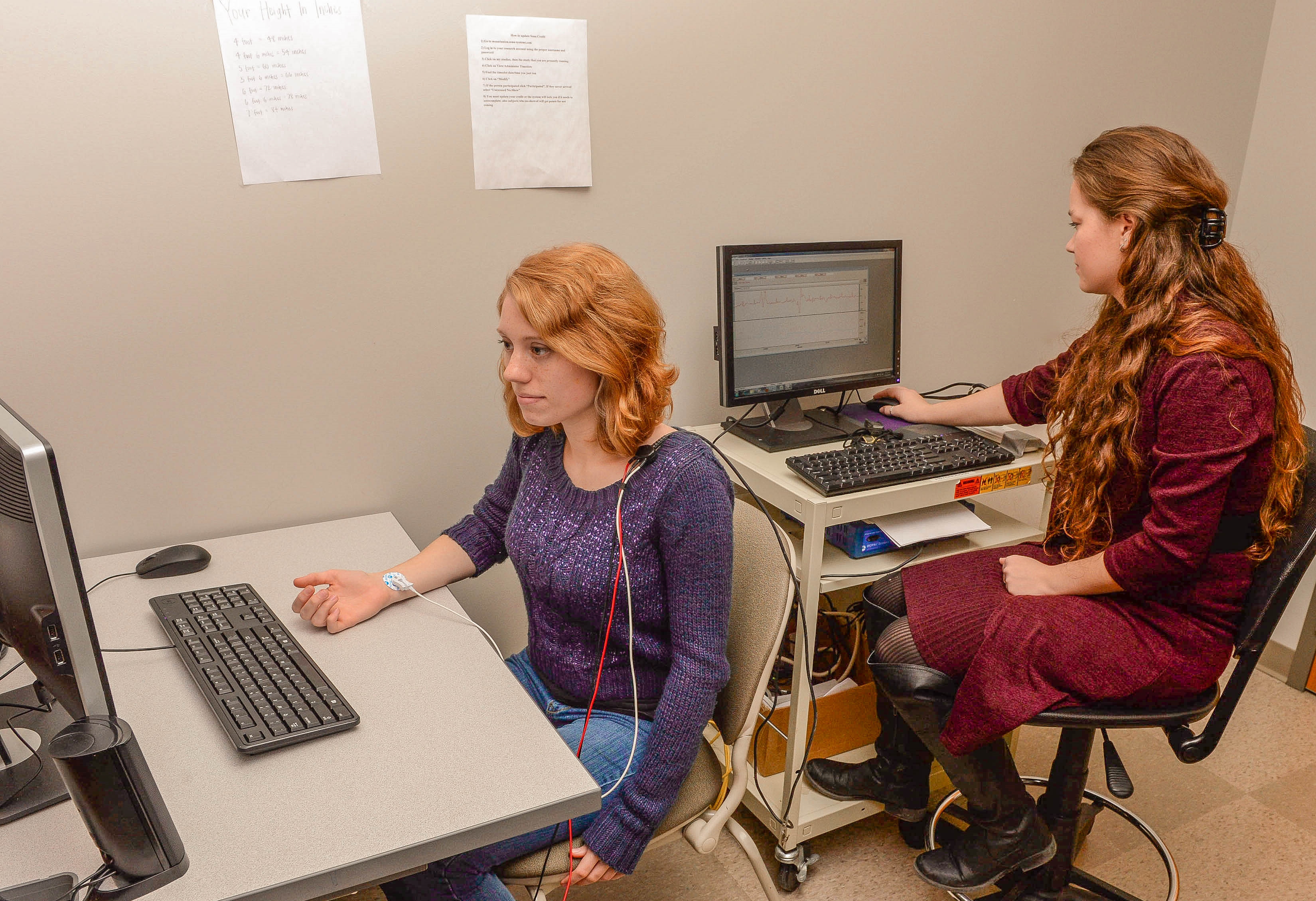 Two female students sitting working on computers in a classroom