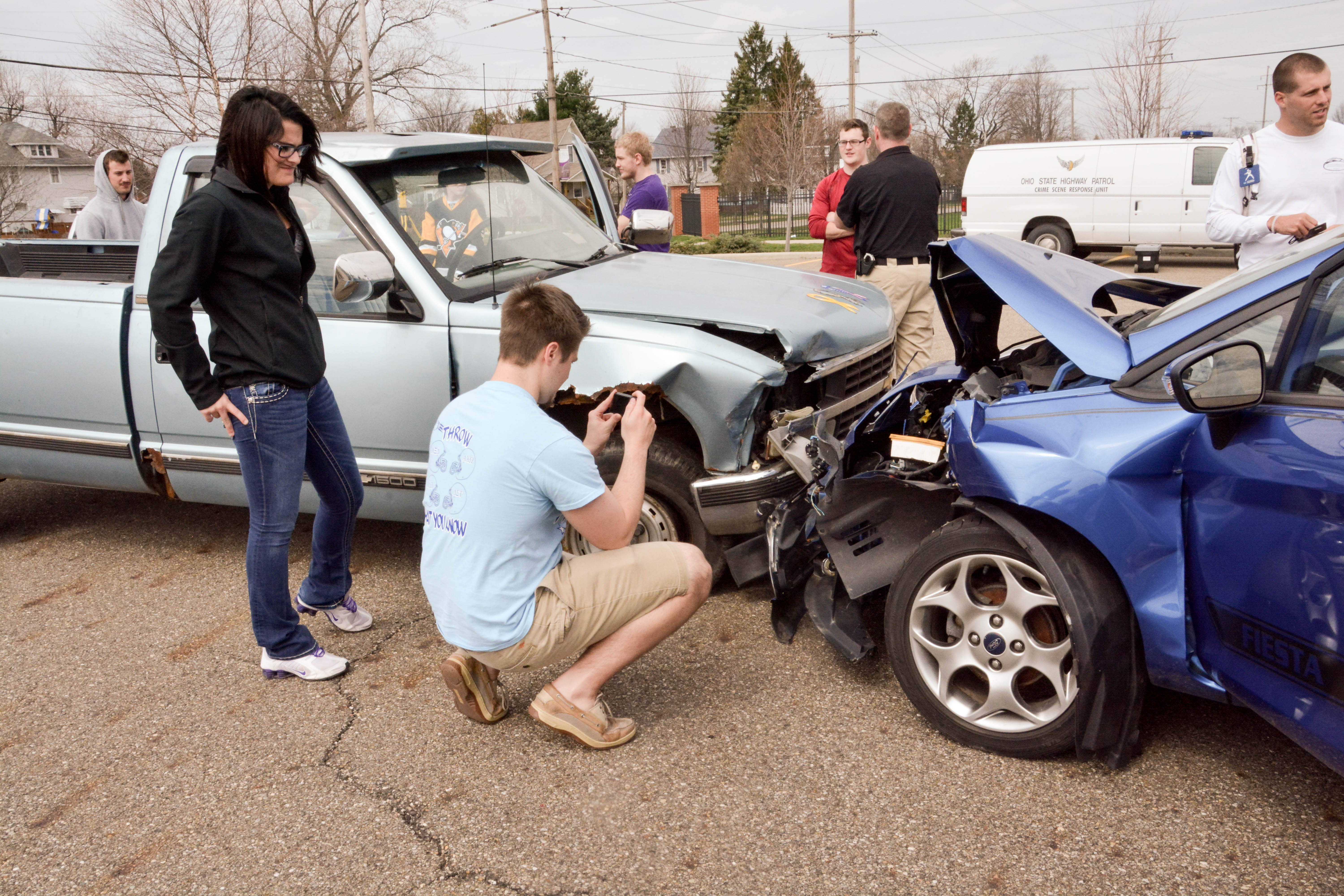 Students with a state highway patrolman at a mock crash scene