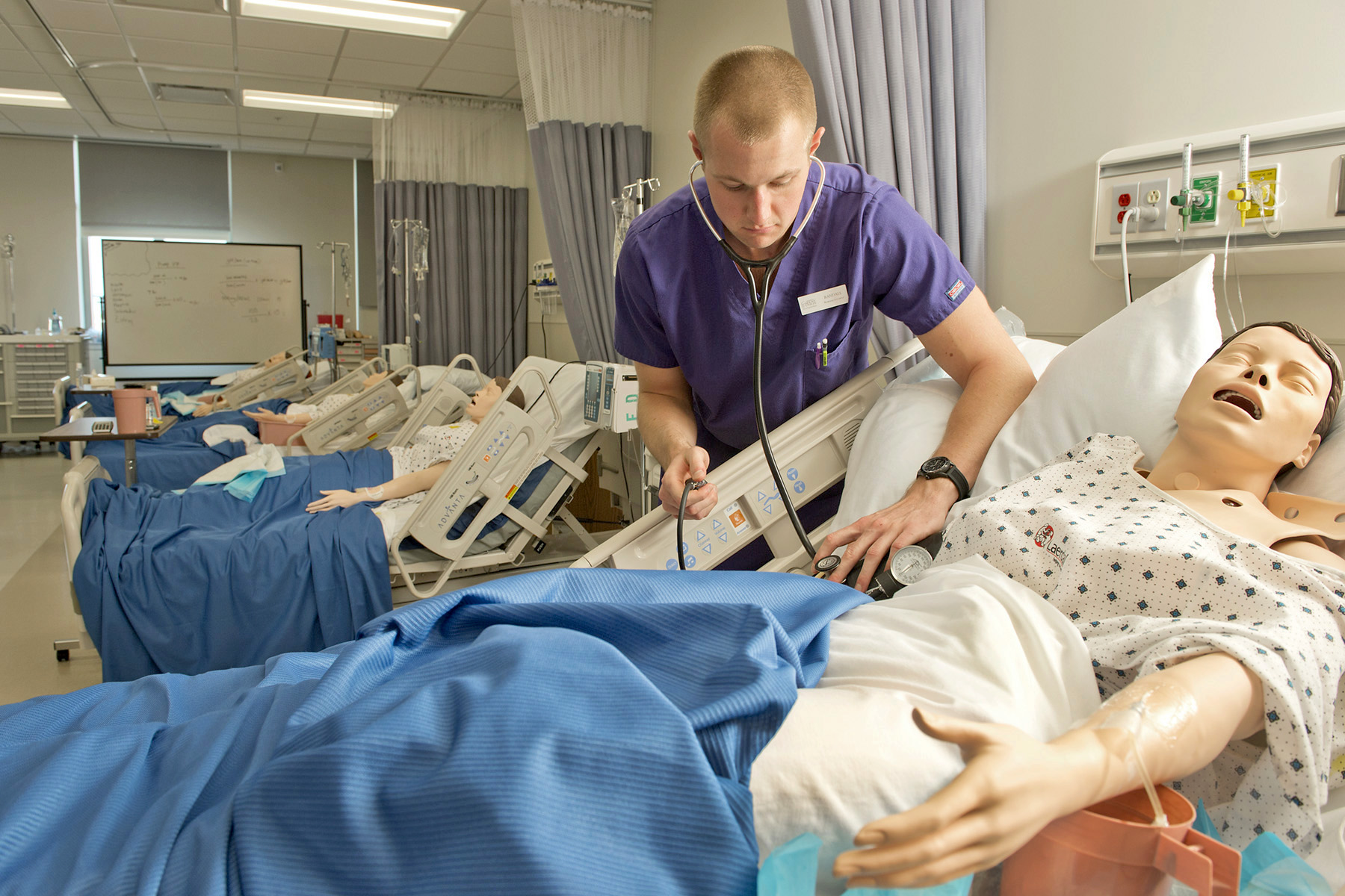 Nursing students and professor going over a project 