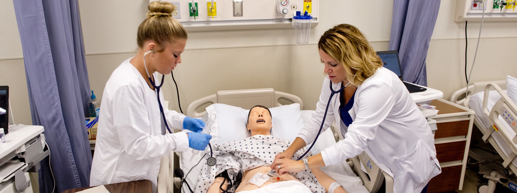 Nursing students and professor going over a project 