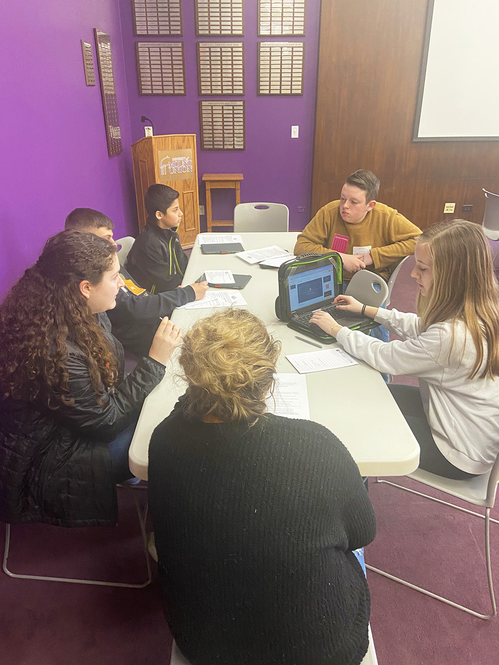 students sitting around a table talking