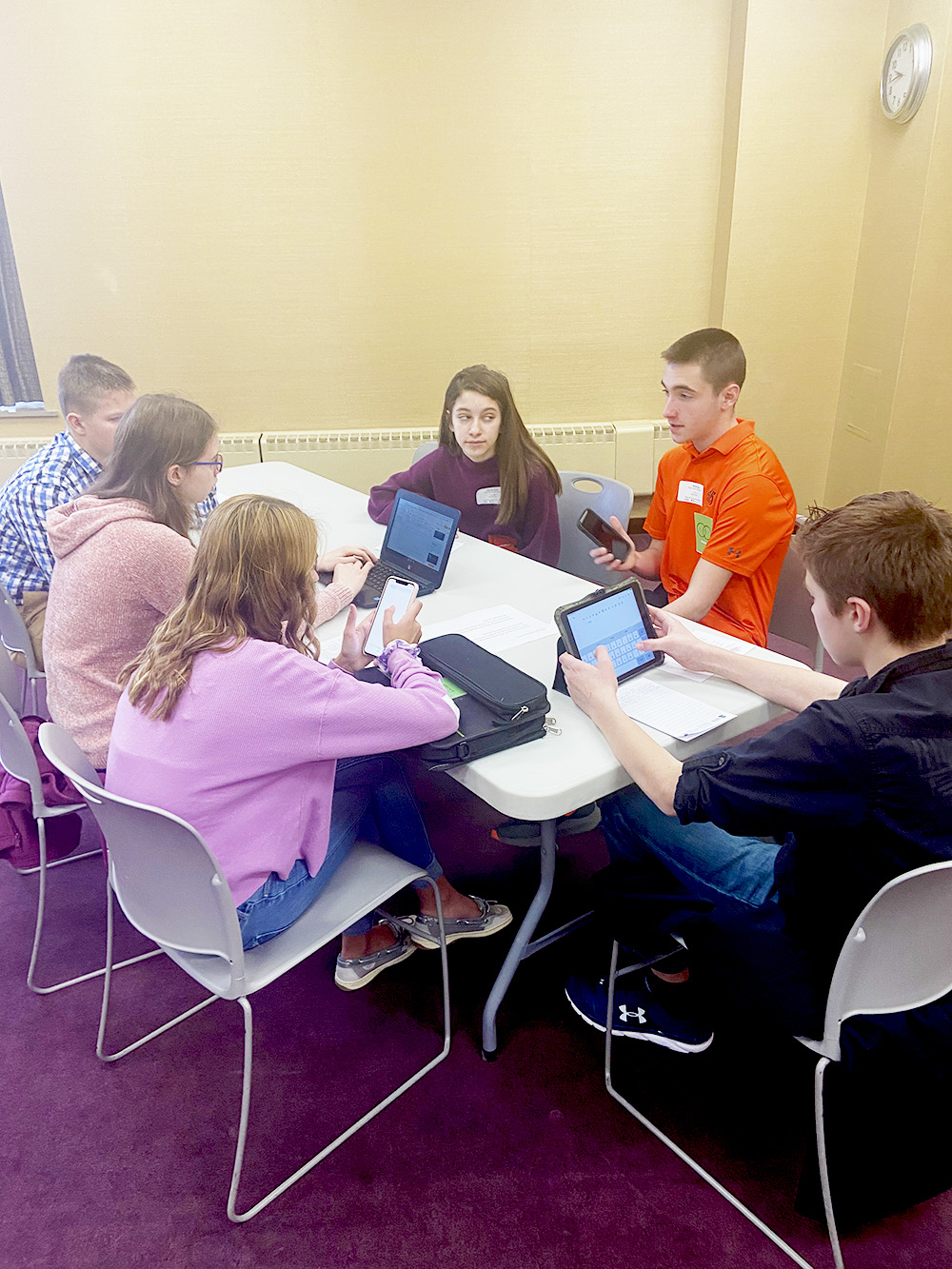 students sitting around a table talking