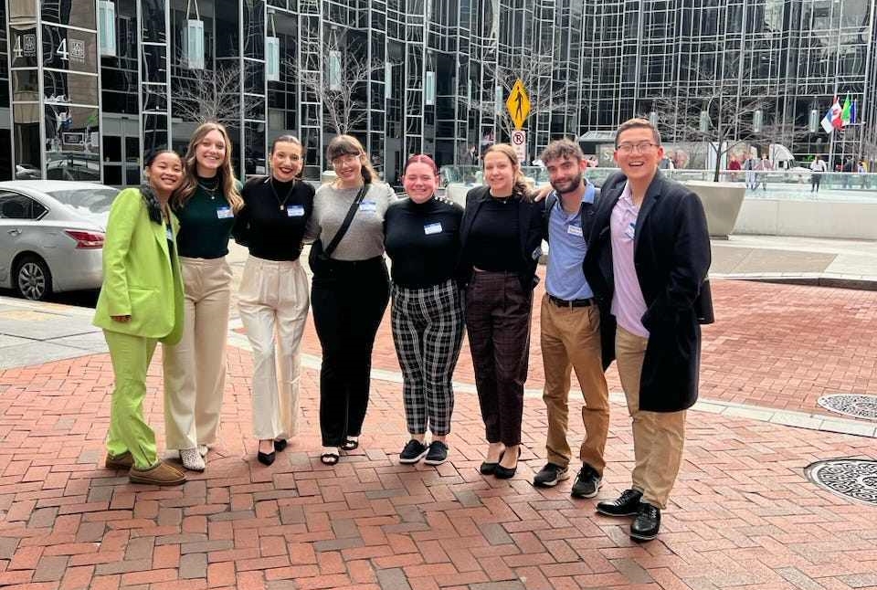 student group posing together while traveling at conference 