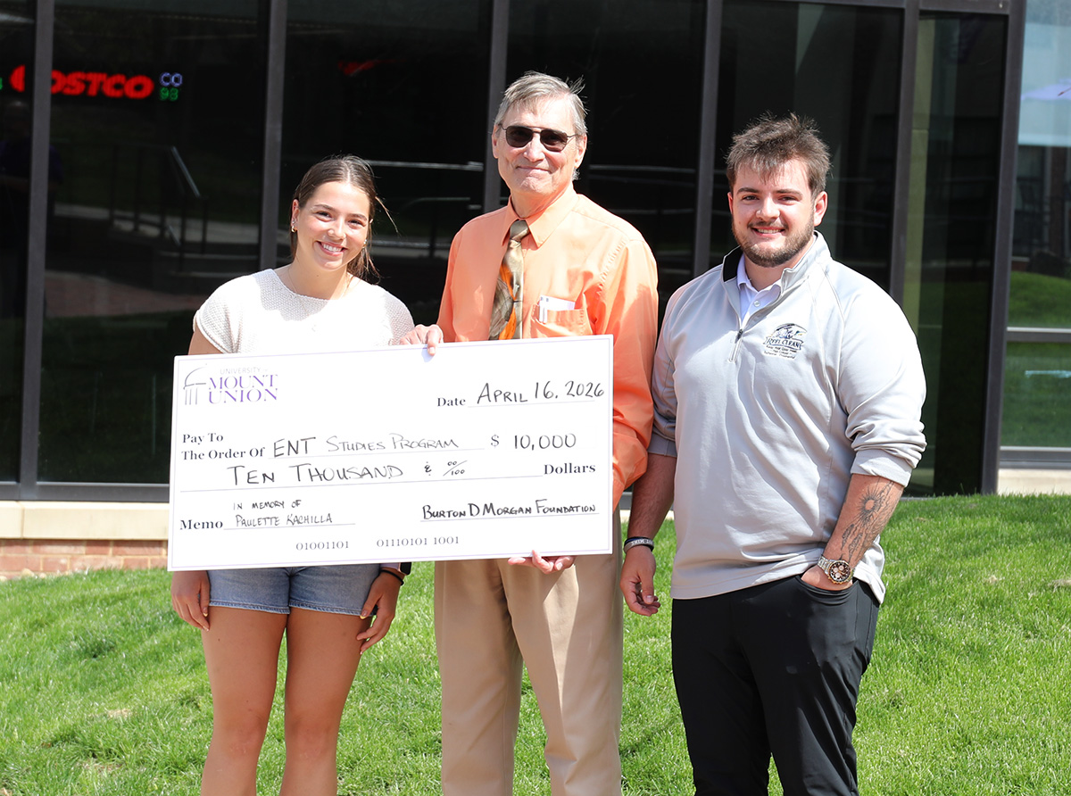May, Beauregard, and Kachilla holding 10 thousand dollar check