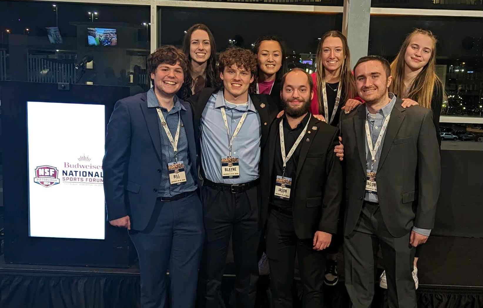 mount union students standing at national sports forum