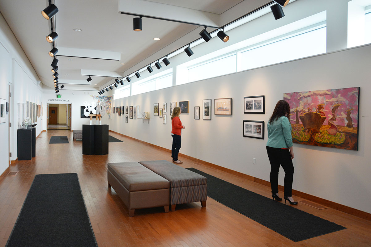 Guests viewing artwork on display in the Sally Otto Art Gallery