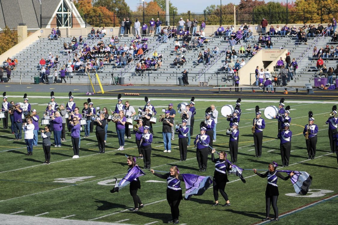 a still shot of the Purple Raider Marching Band performing at halftime
