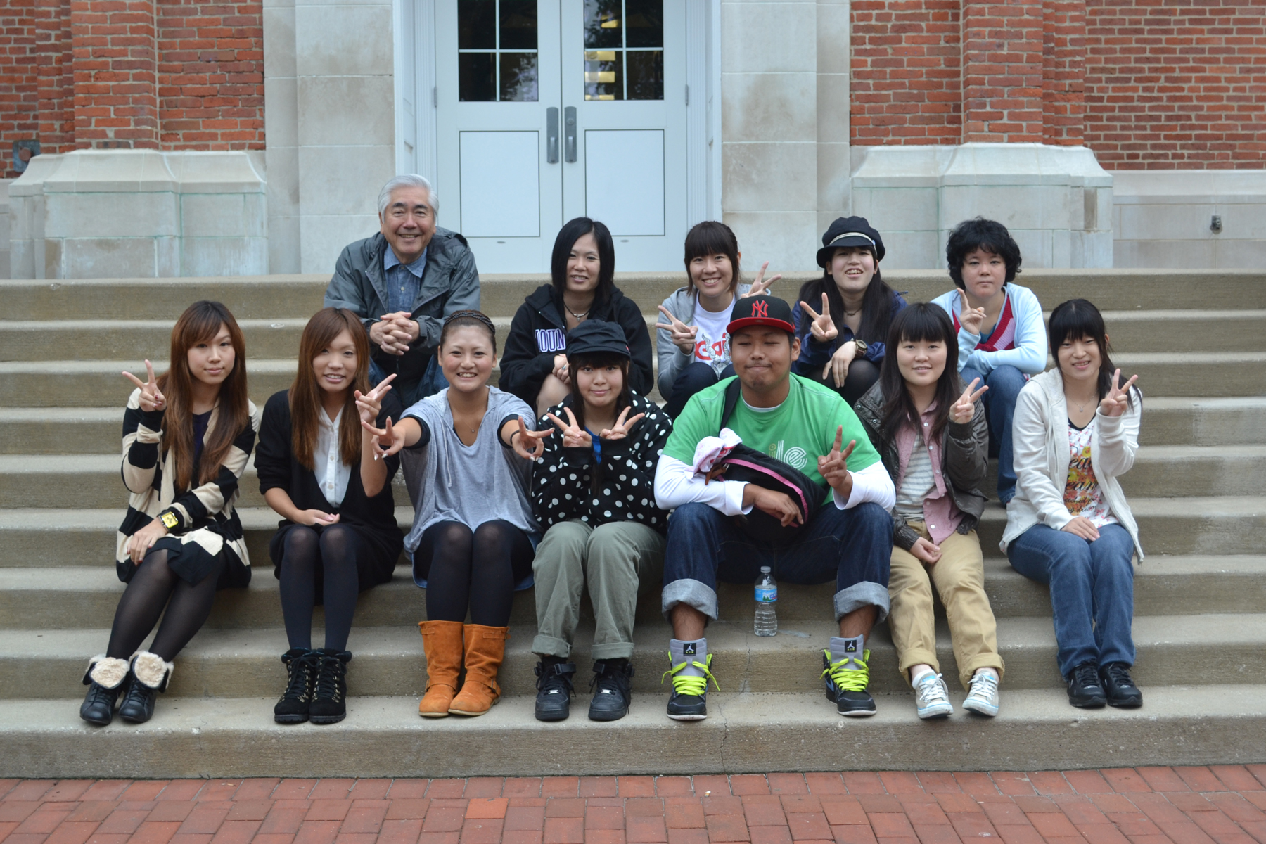 students from tezukayama university holding peace signs