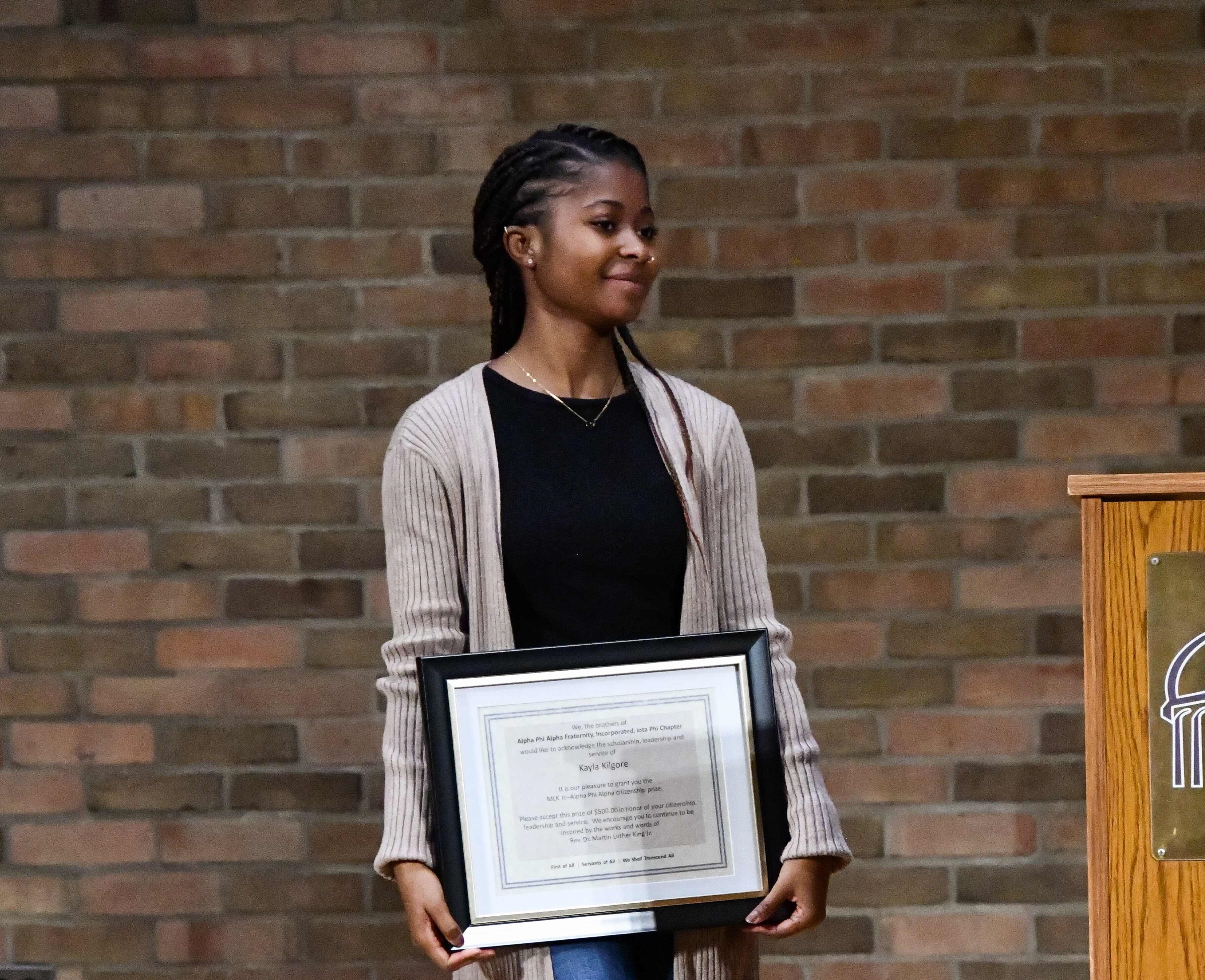 kayla kilgore standing with award