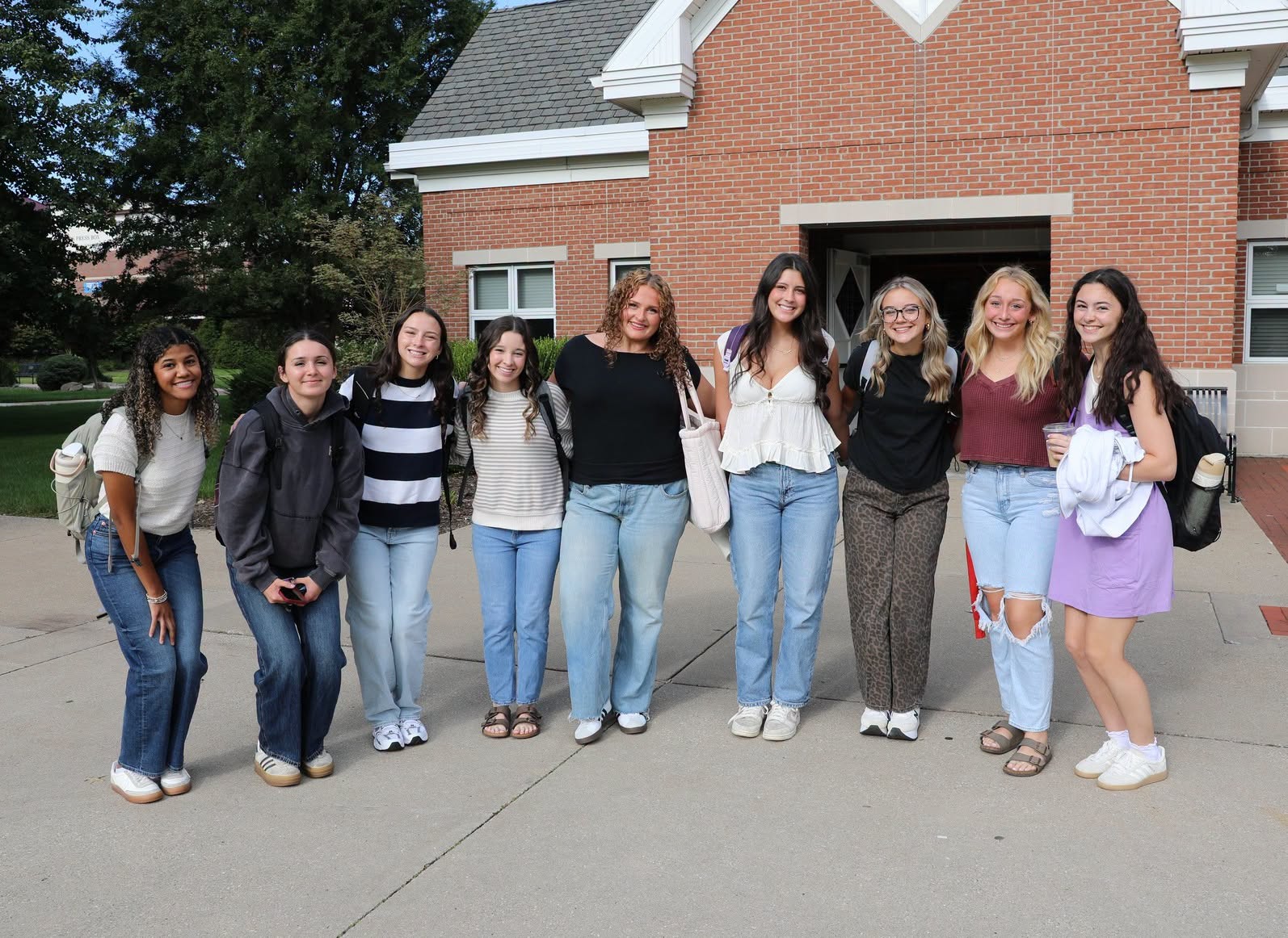 Group of students posing in front of campus chapel