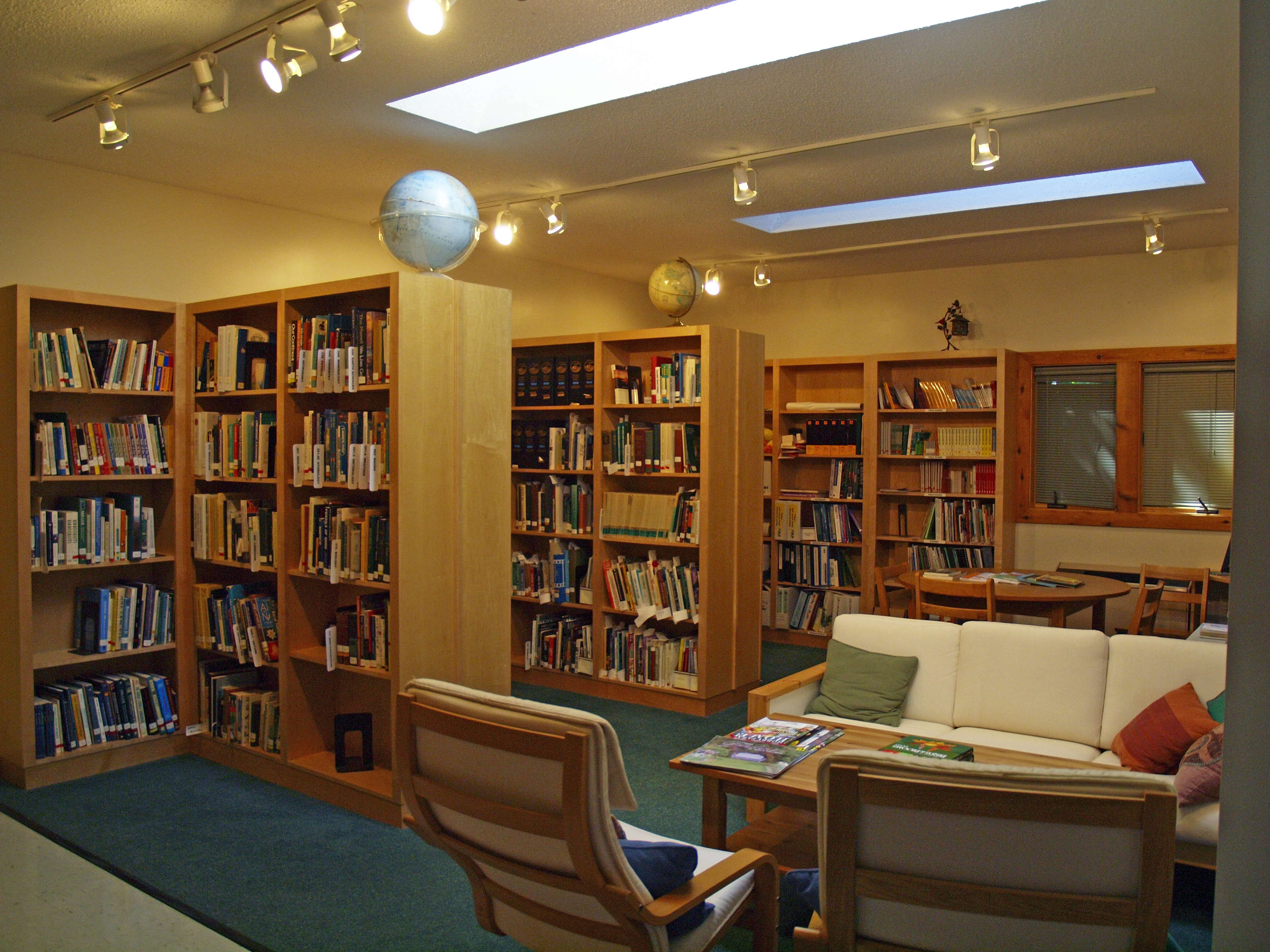 A study space with bookshelves and couches located in the Nature Center