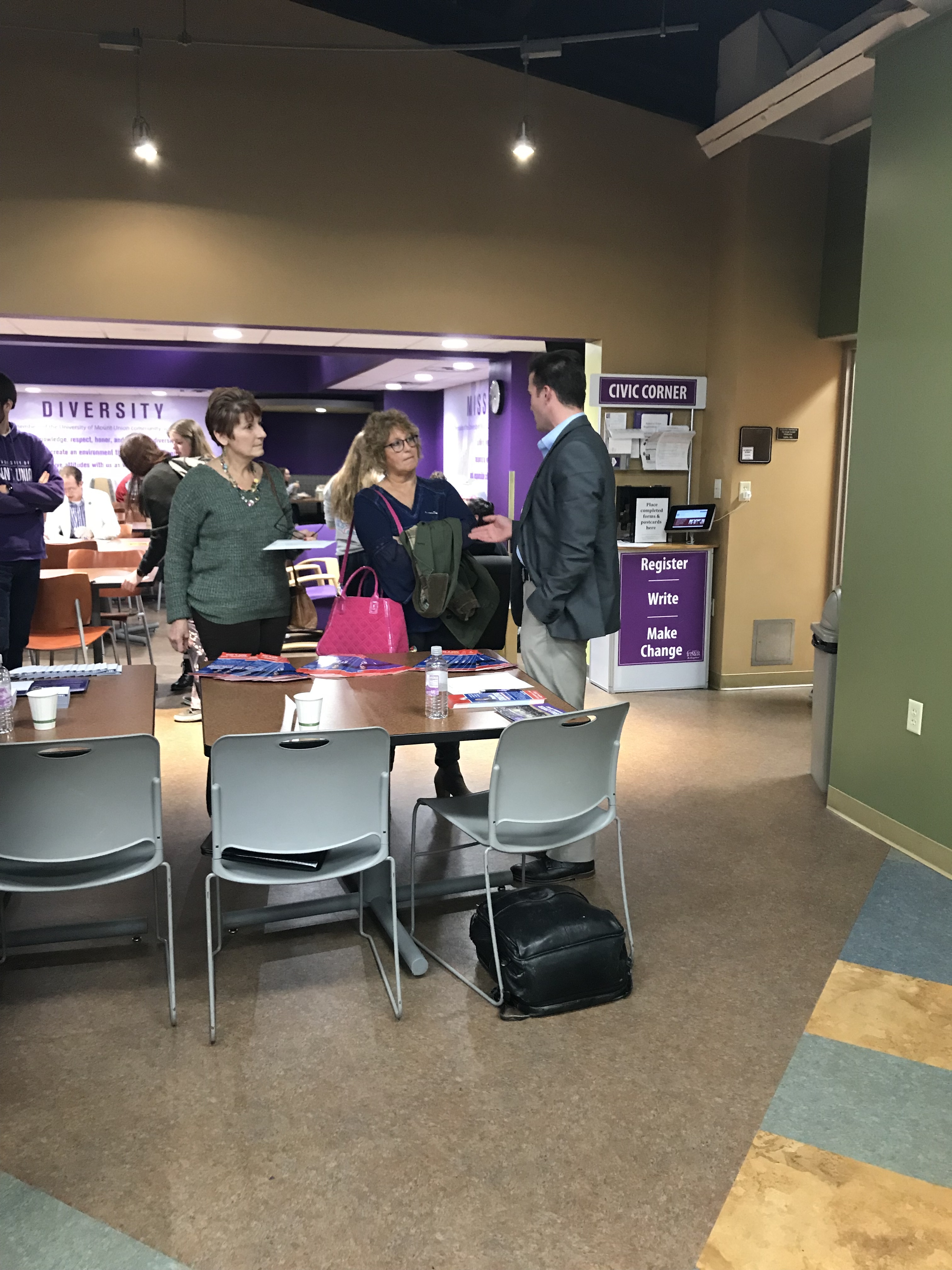 Student standing with community members