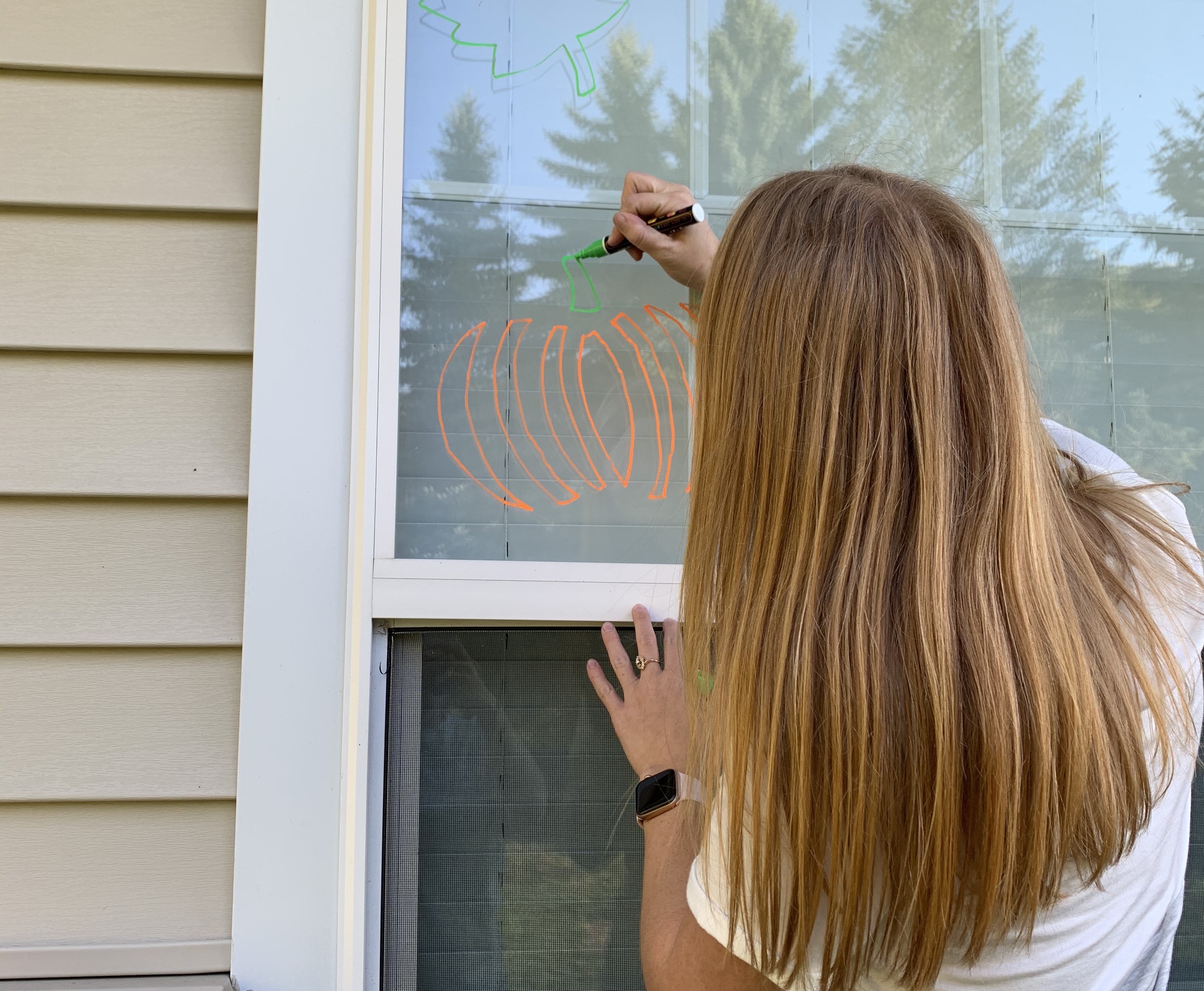 student drawing on window