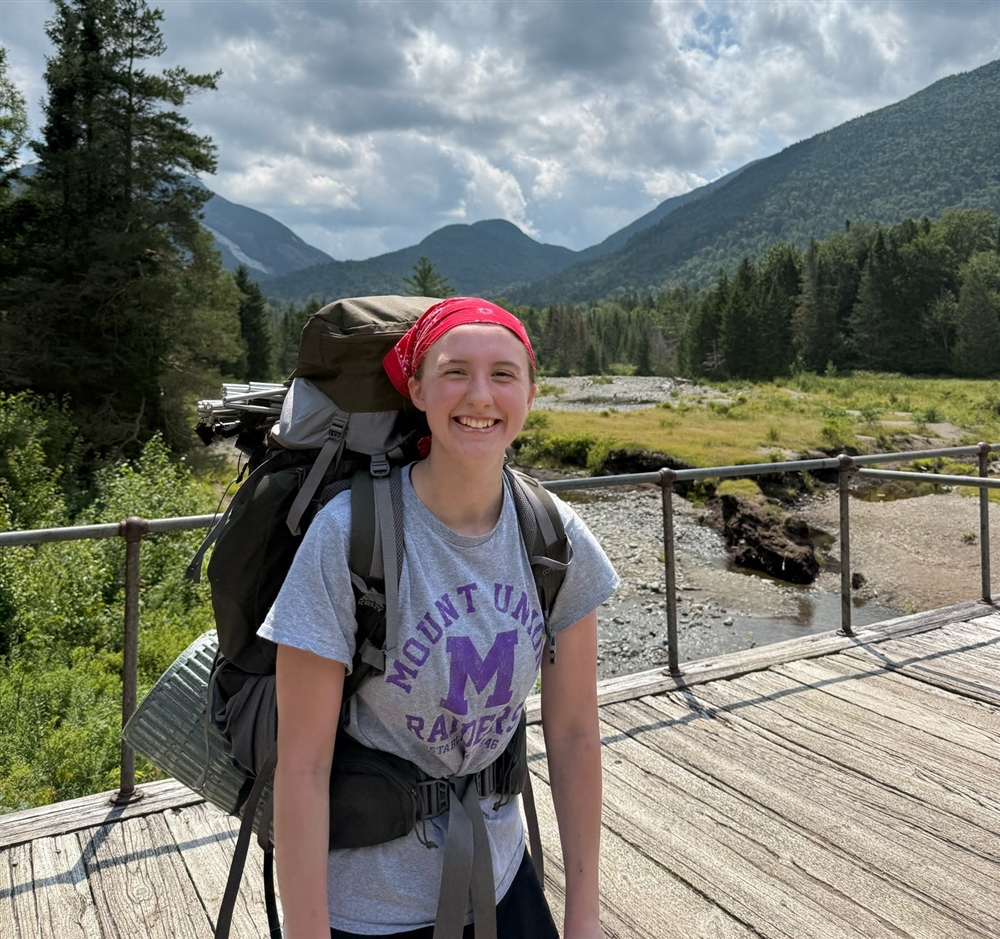 student smiling while hiking